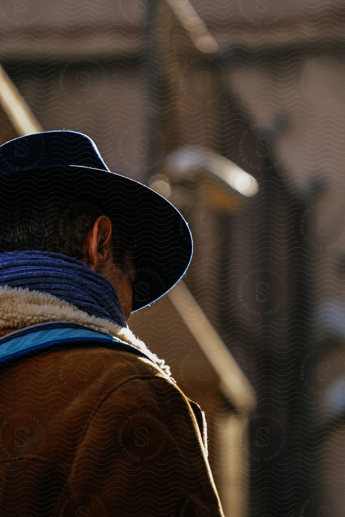 A rancher standing outdoors wearing a large hat