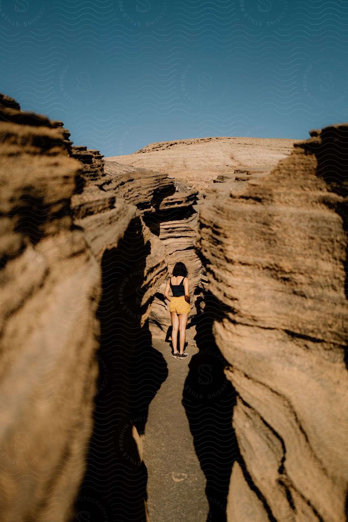 A woman standing in a canyon she is hiking in