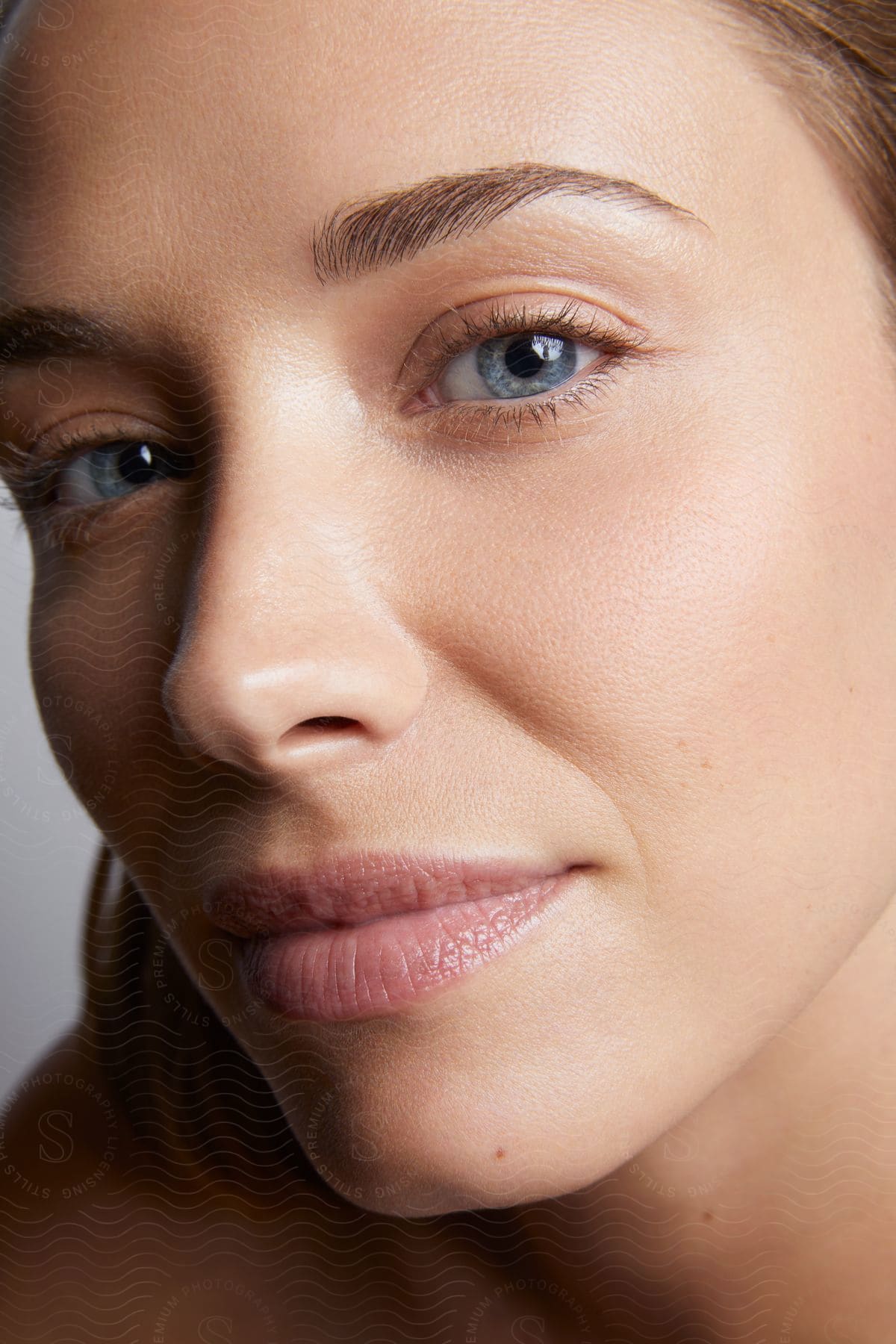 A portrait of a woman with blue eye colors looking straight.