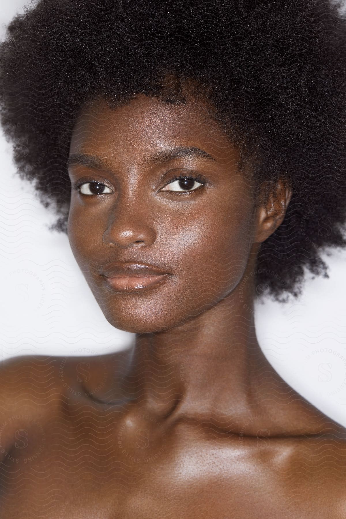 A black lady has an Afro style hair.