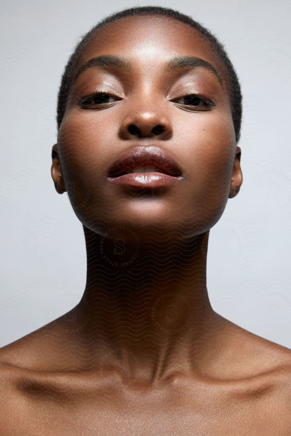 Woman raises her chin while looking forward.