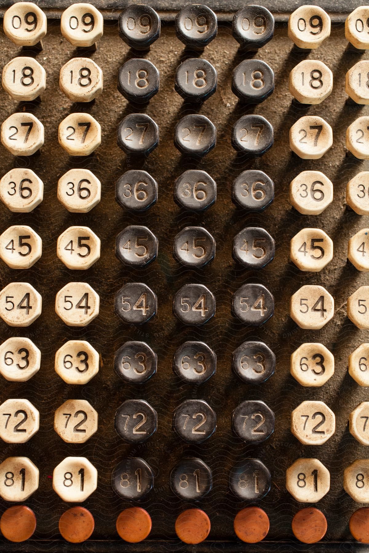 An array of old and numbered buttons that repeat sideways and grow across rows.
