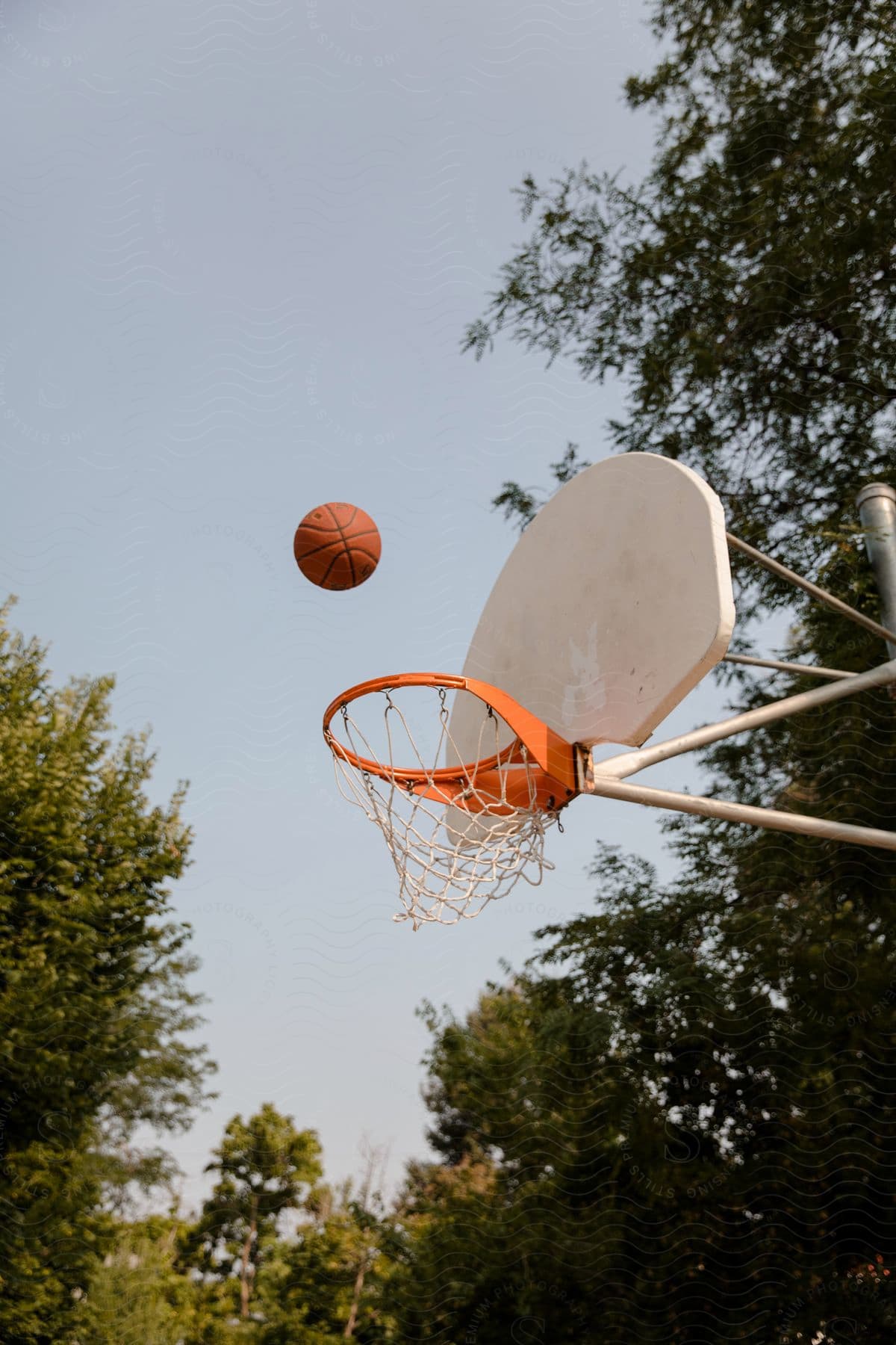 a basketball is thrown above the hoop outside