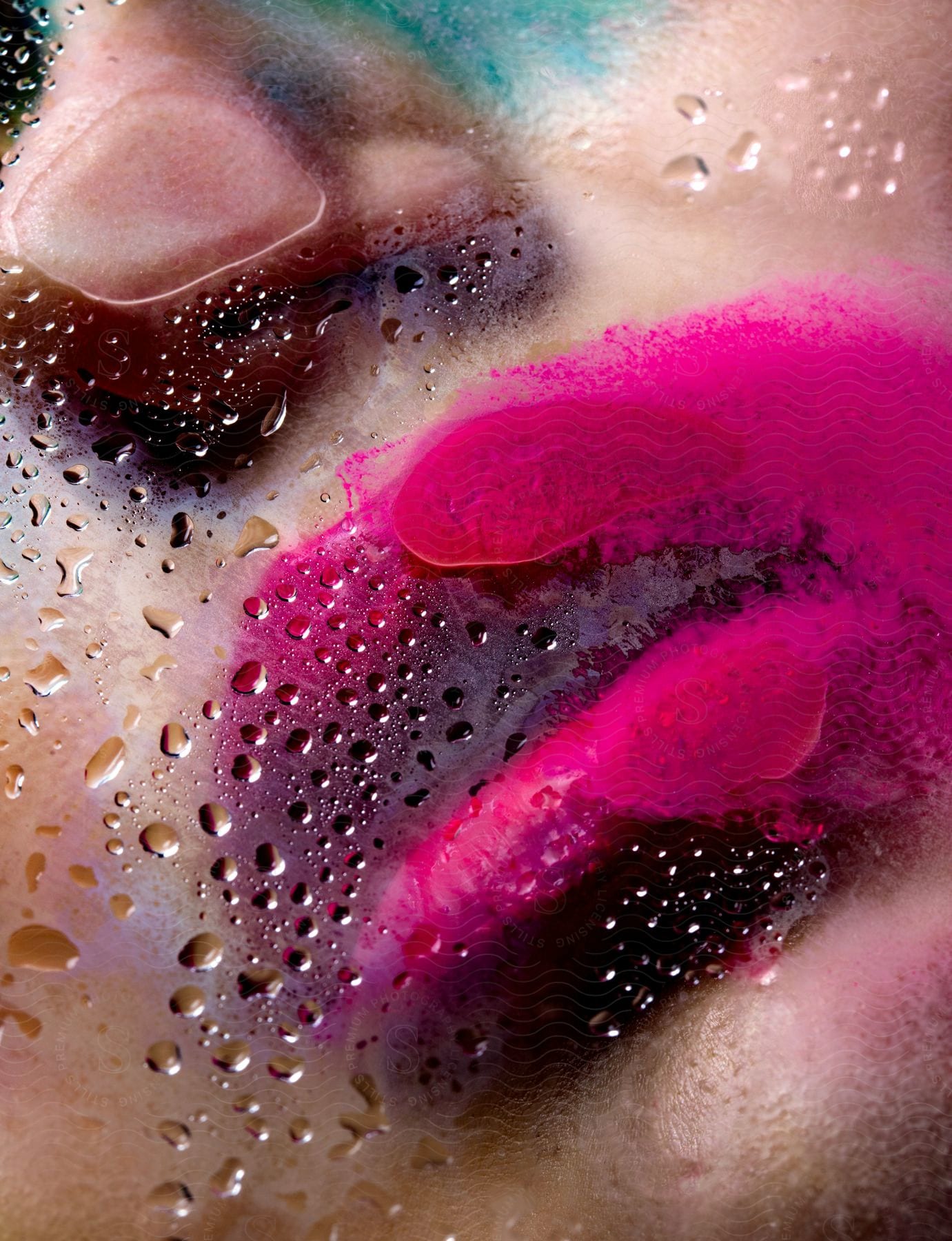 A Woman's Lips, Smeared With Pink Lipstick, Pressed Against A Glass Window, Water Droplets And Lip Streaks Marring The Surface