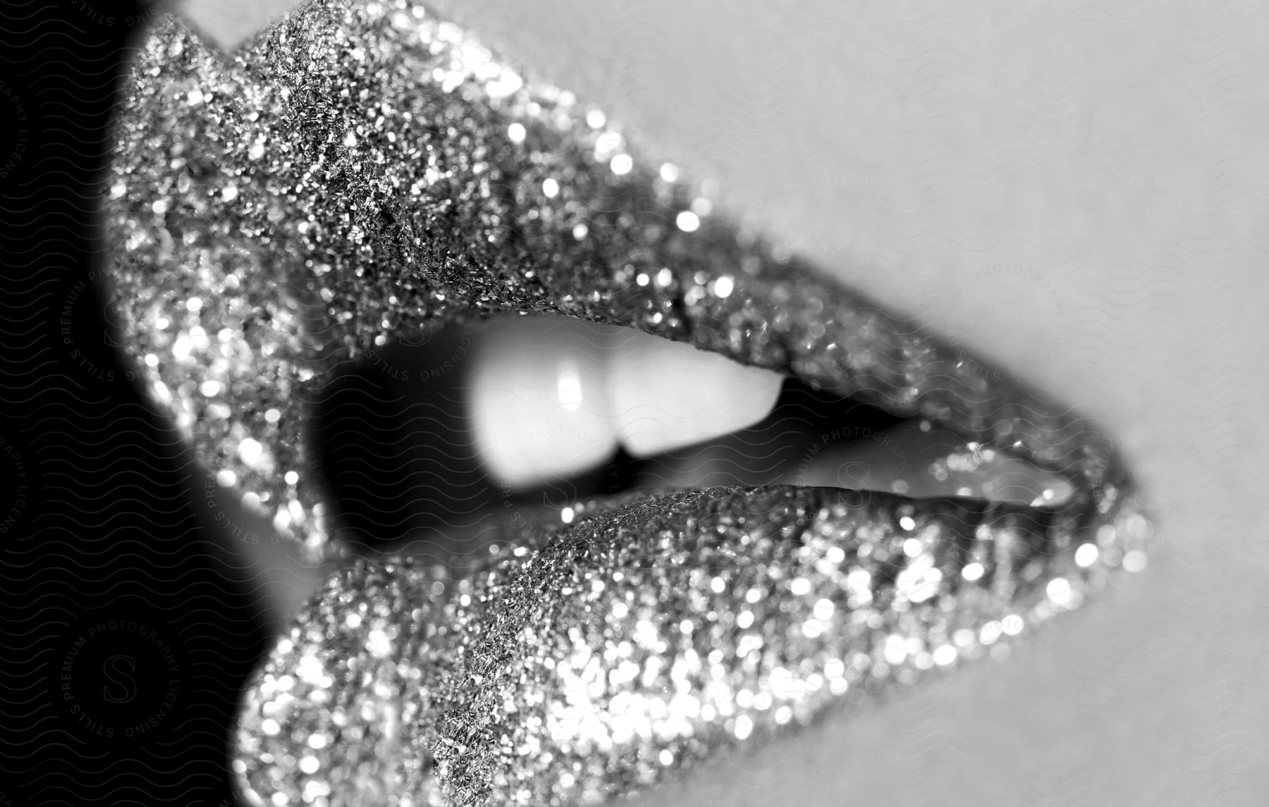 Extreme close-up on the mouth with a glossy gloss.