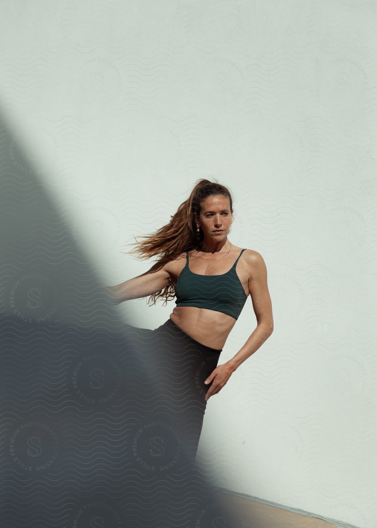 Woman practicing yoga wearing sportswear.