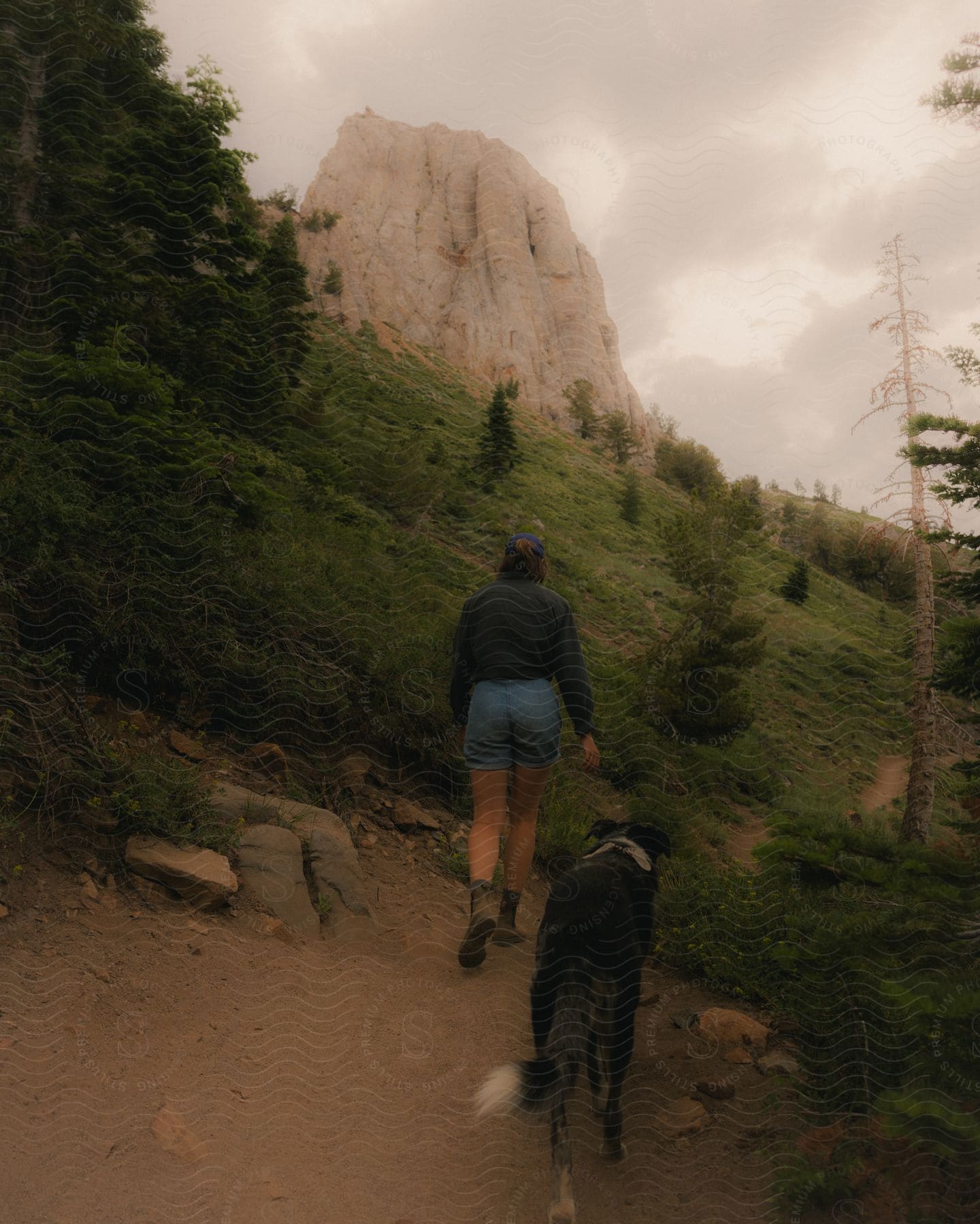 A woman and her dog going out for a hike