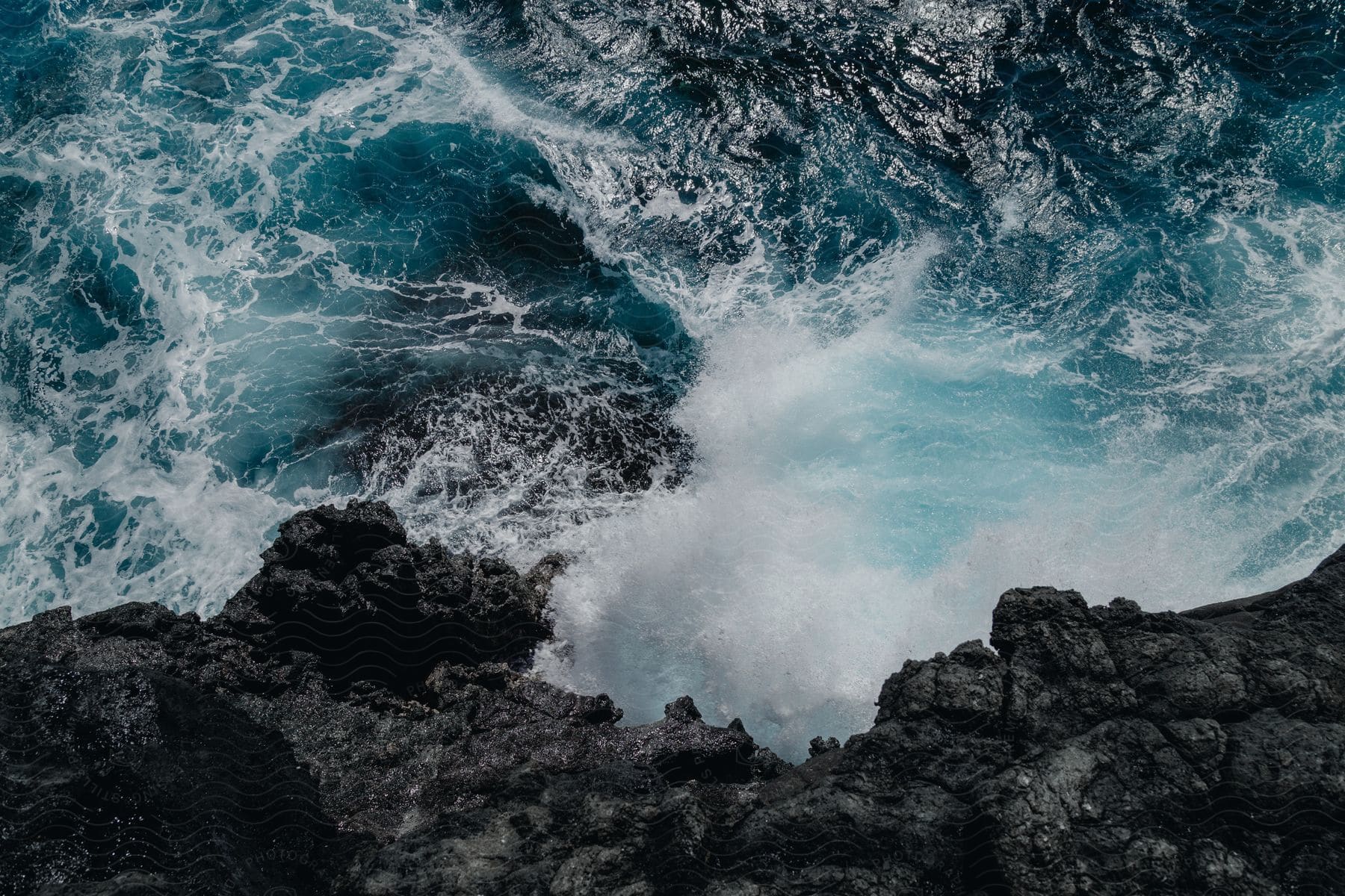 waves violent crash onto a rocky cliff