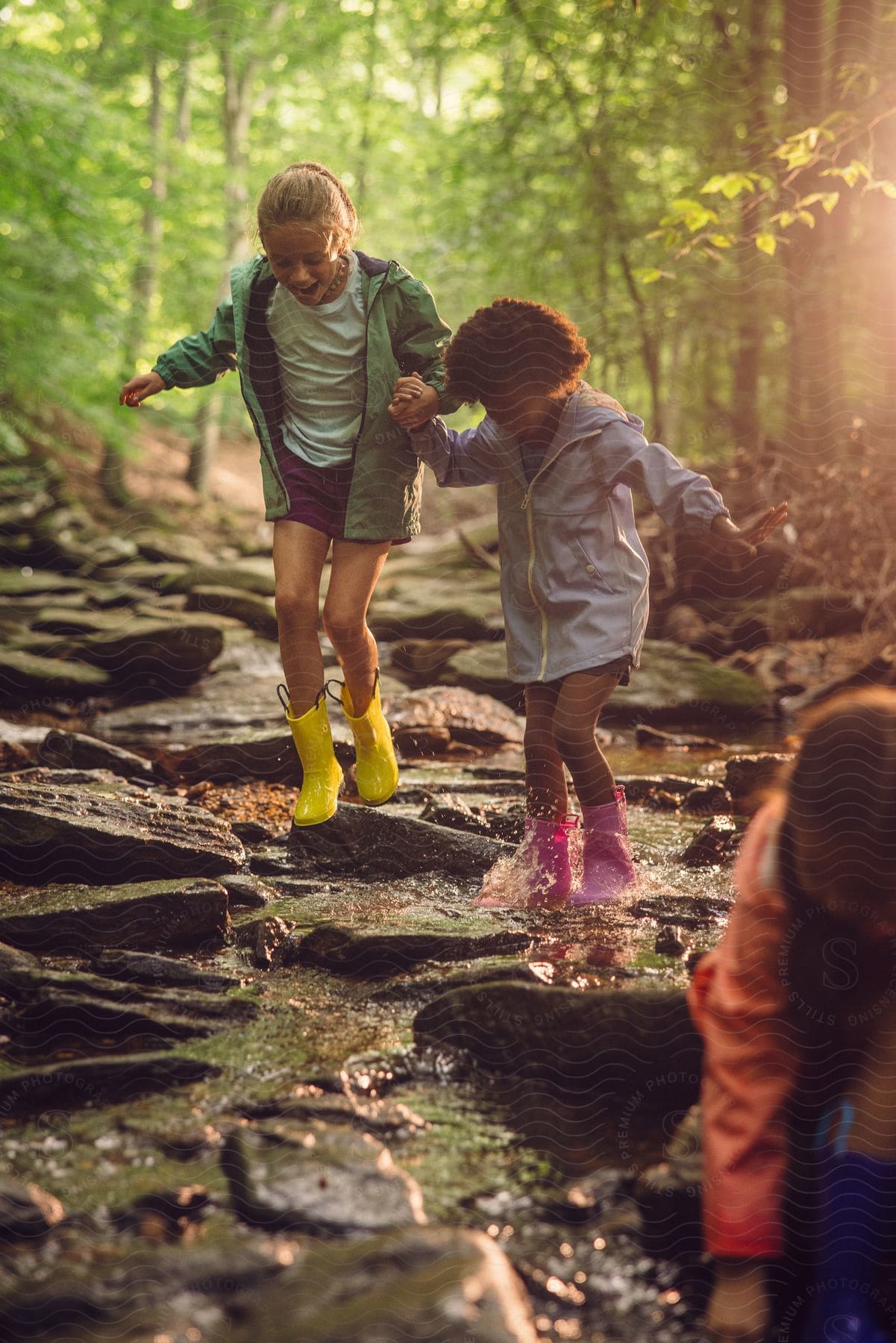 Two girls playing out in a forest