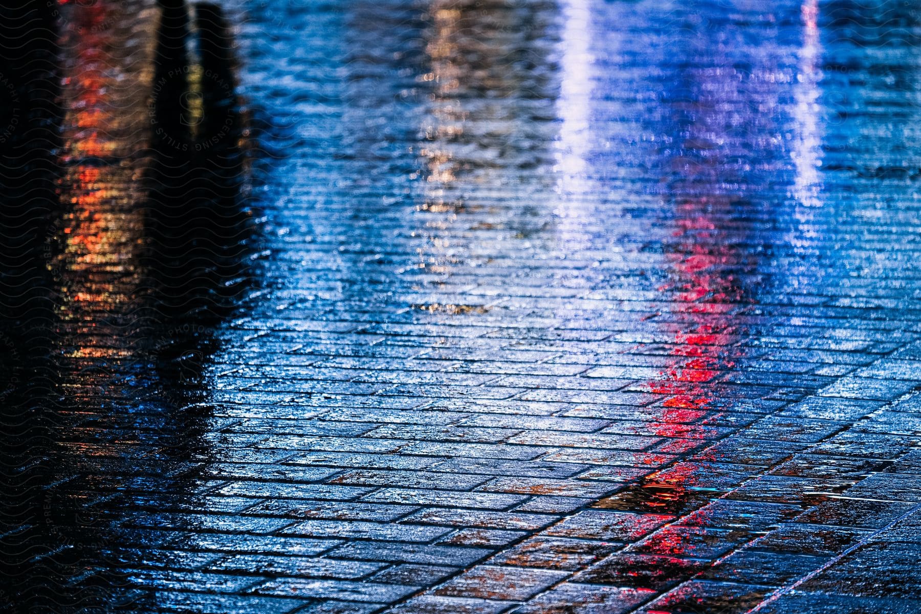 A floor all wet with city lights reflecting.