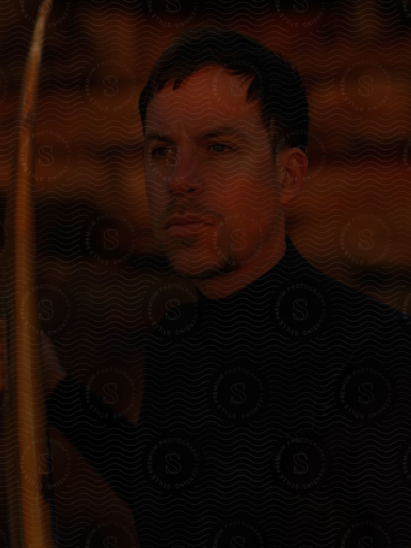 Portrait of man looking into space wearing black sweater