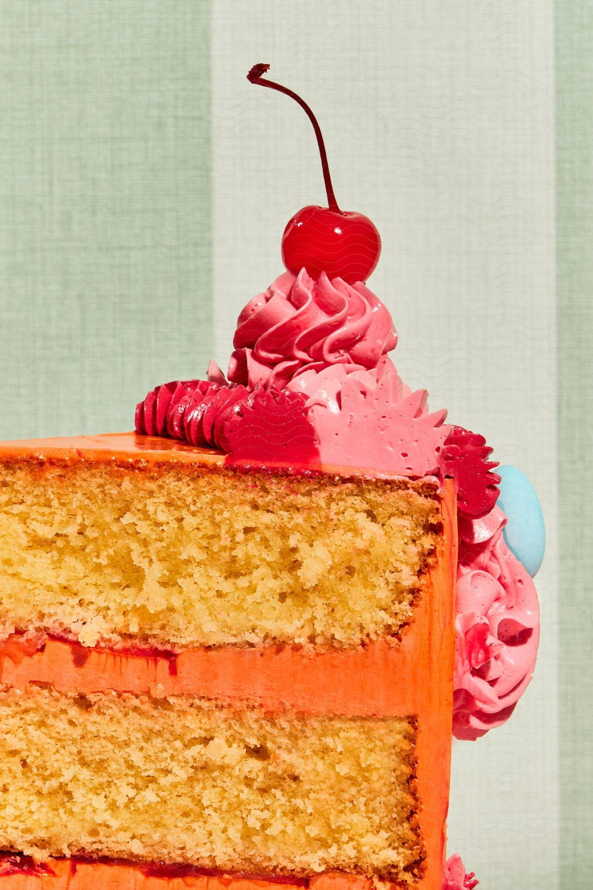 Stock photo of a slice of cake with a cherry on top.