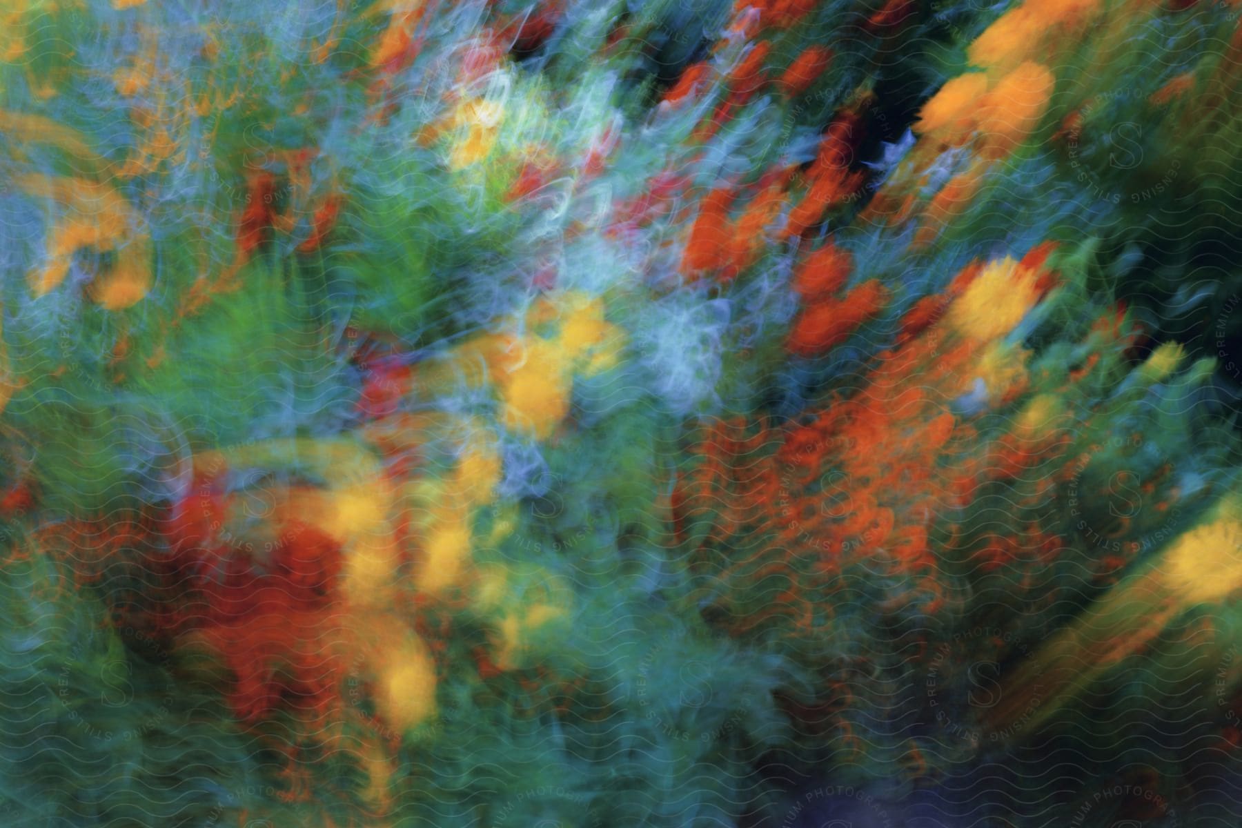 A blurred painting with splashes of color approximating flowers