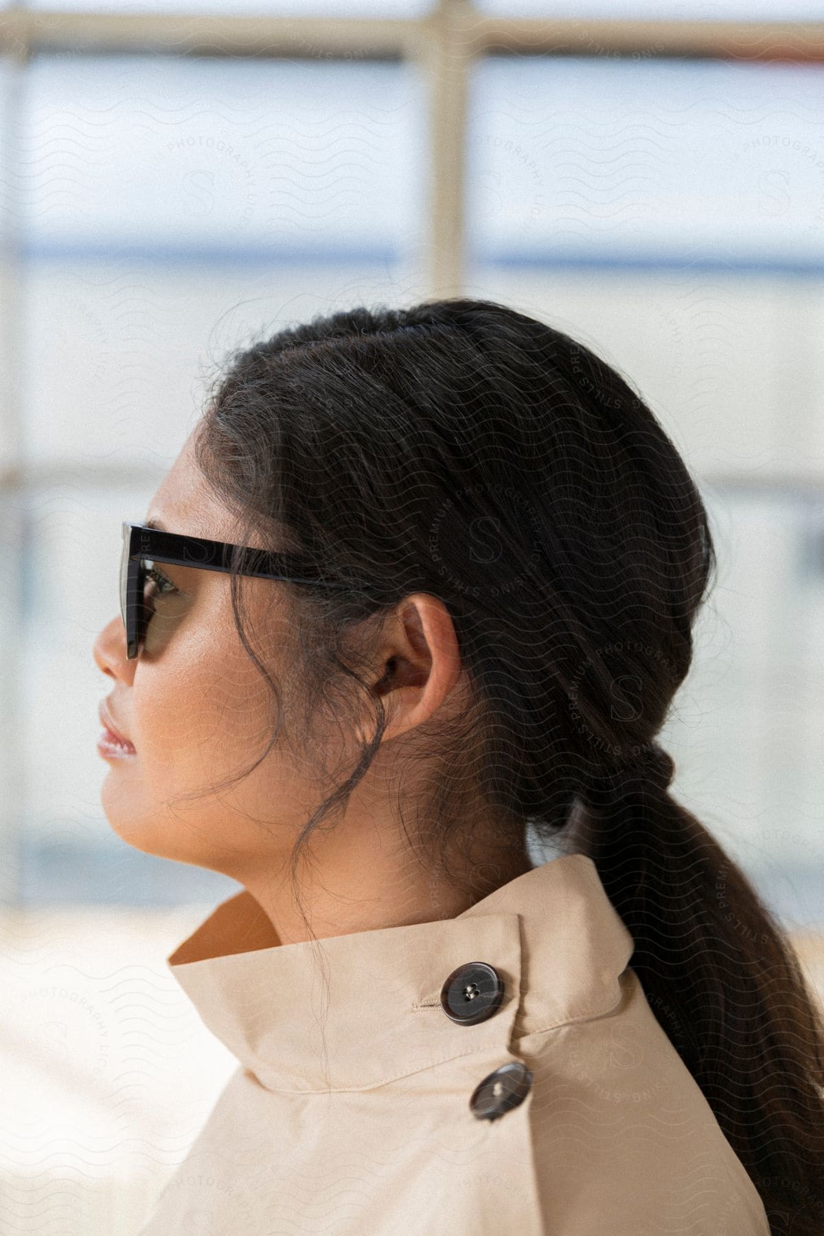 An asian woman with sunglasses, in profile.