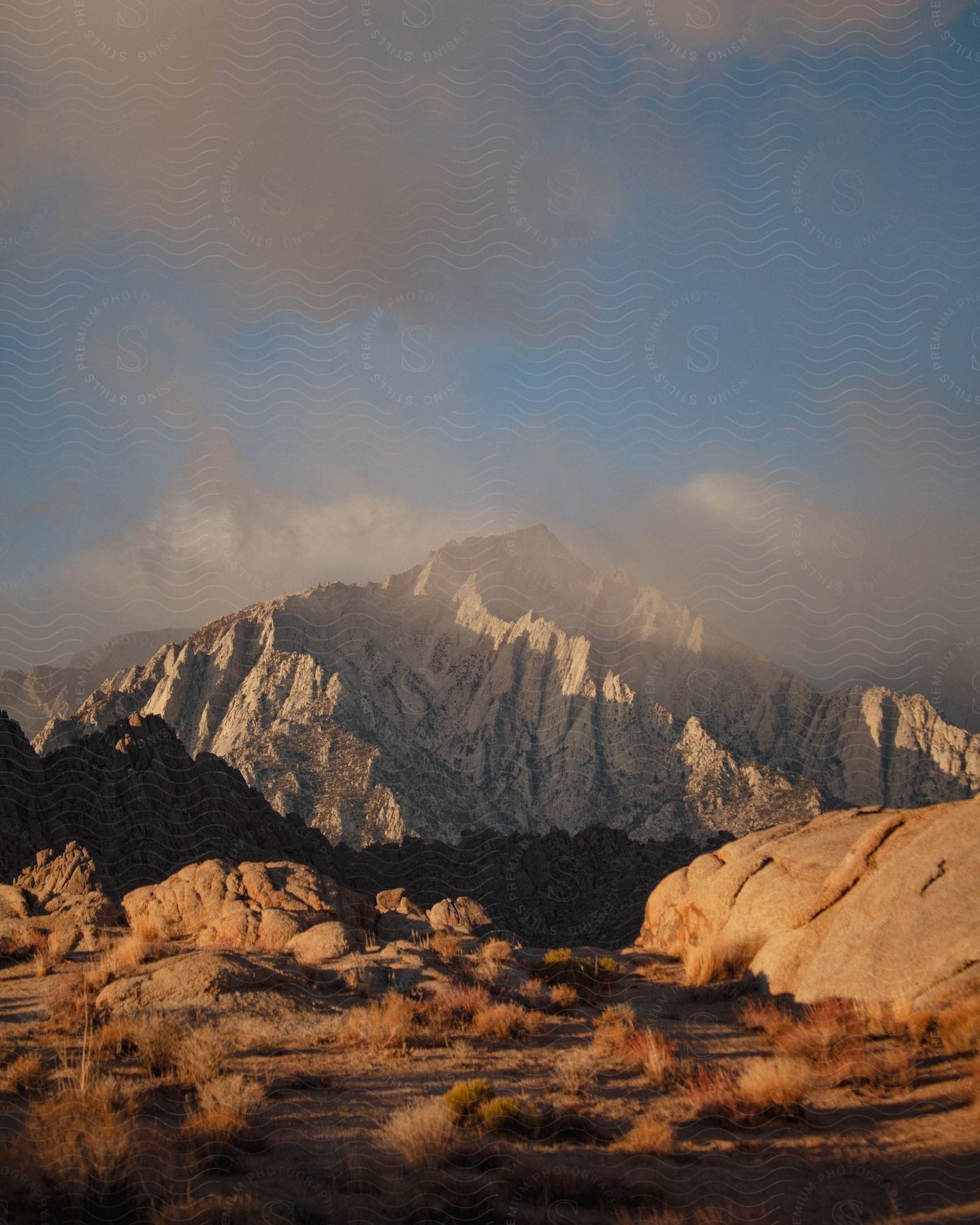 A dry desert land with mountains near with snow present.