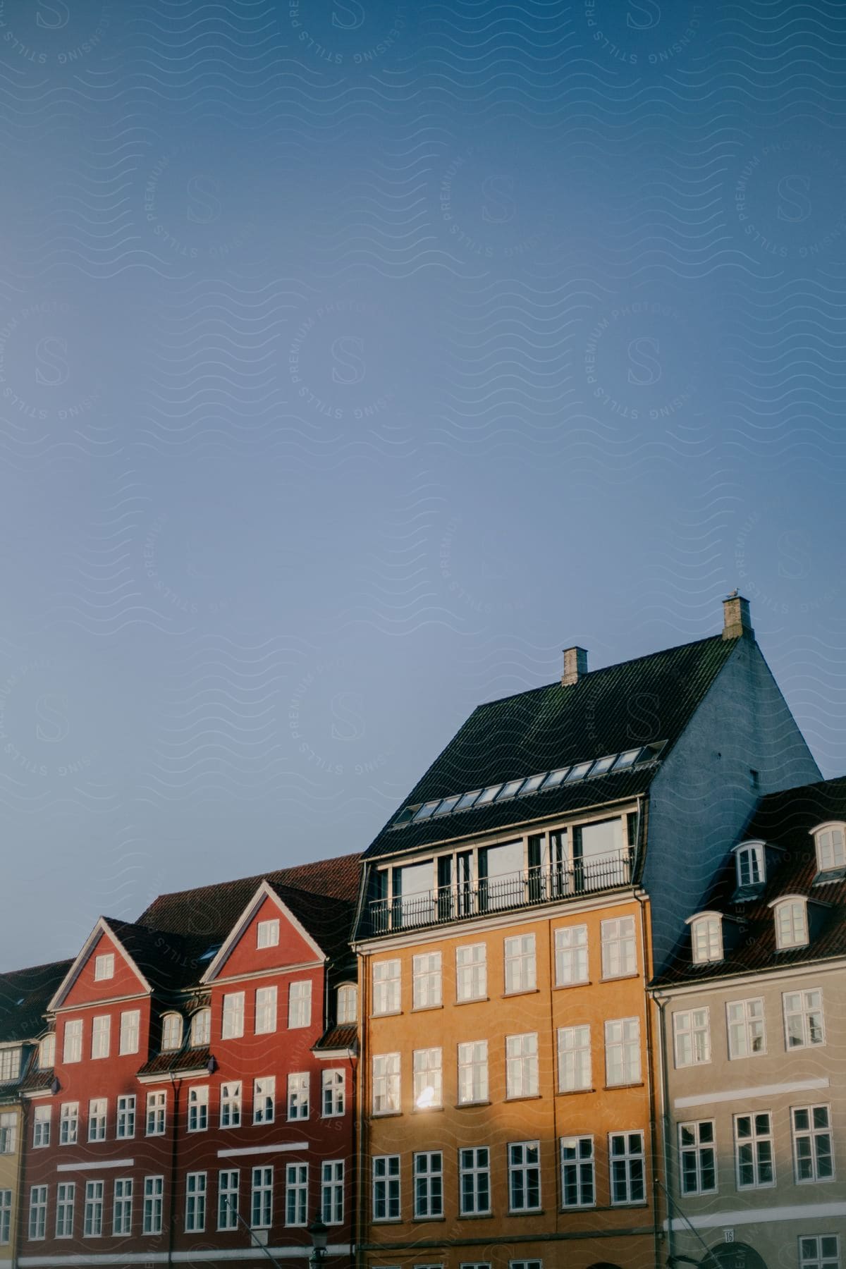 Some houses and buildings outdoors with sunlight shining on them