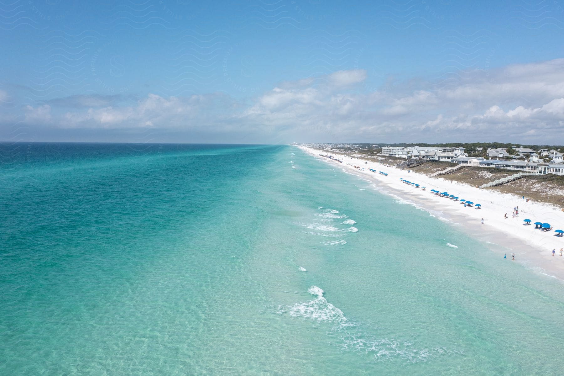 waves move toward the shore of a white sand beach