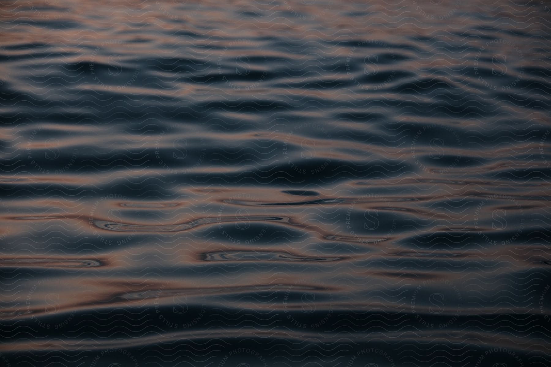 Oil Residue Collects On The Surface Of A Large Water Body At Dusk