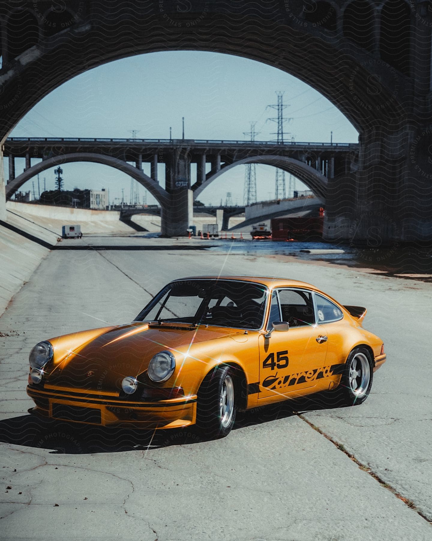 A Porsche sports car sitting in the Los Angeles river.