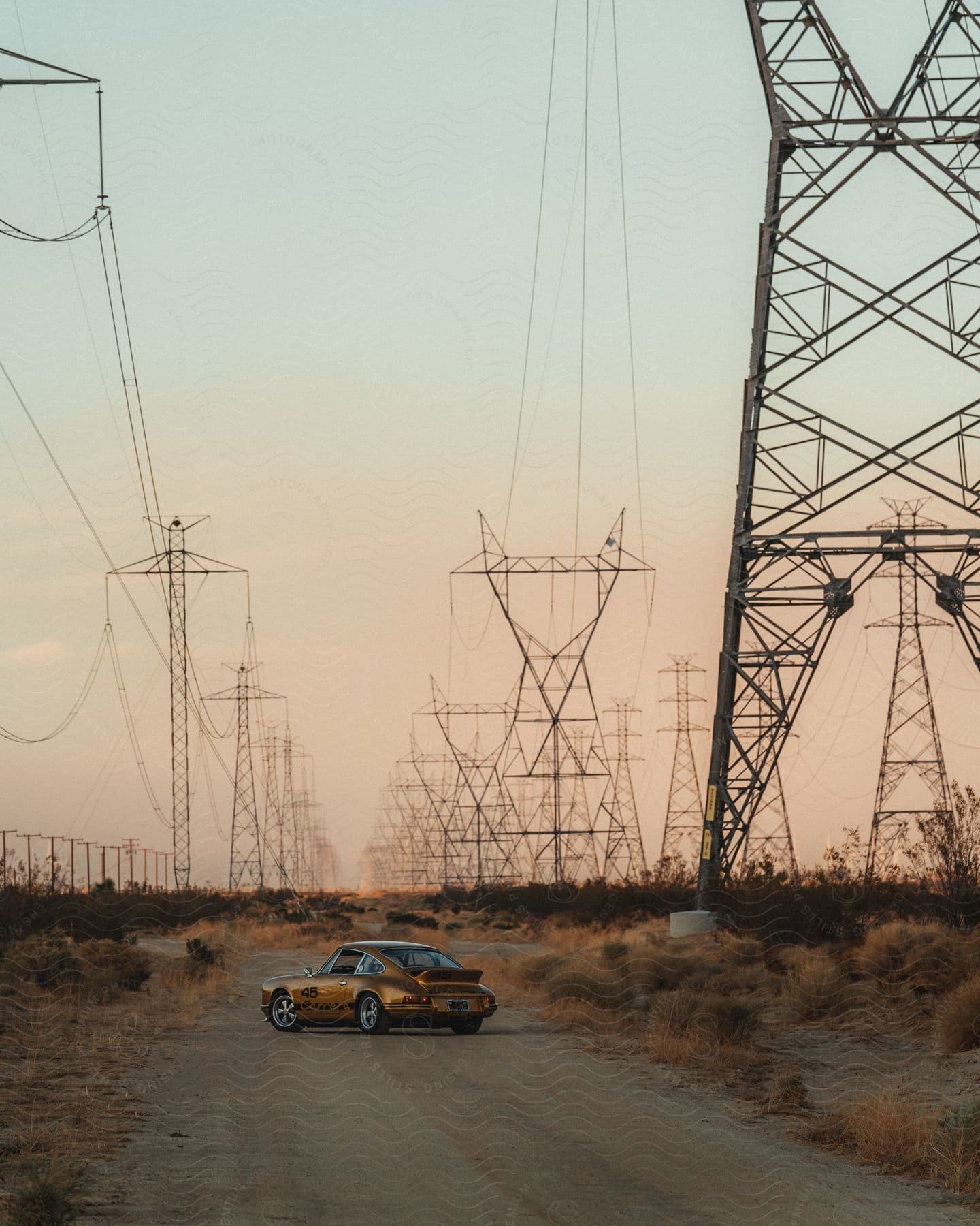Vintage Porsche in the midst of electric power towers.