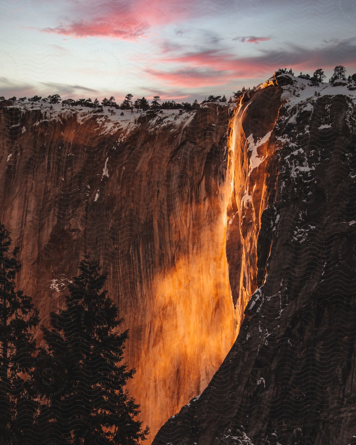 orange lava lights up the side of a mountain