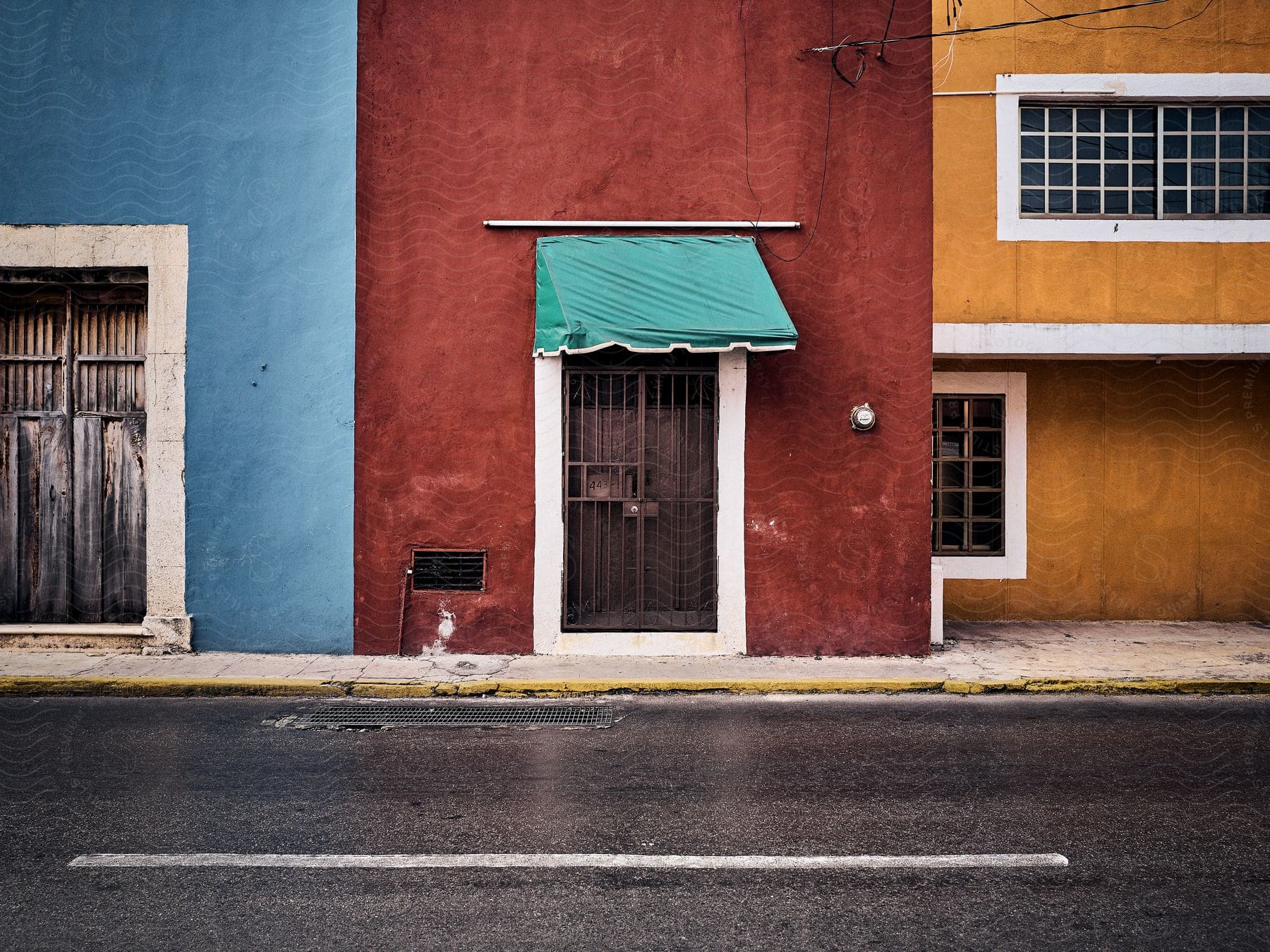 buildings along a city block are painted in bold colors