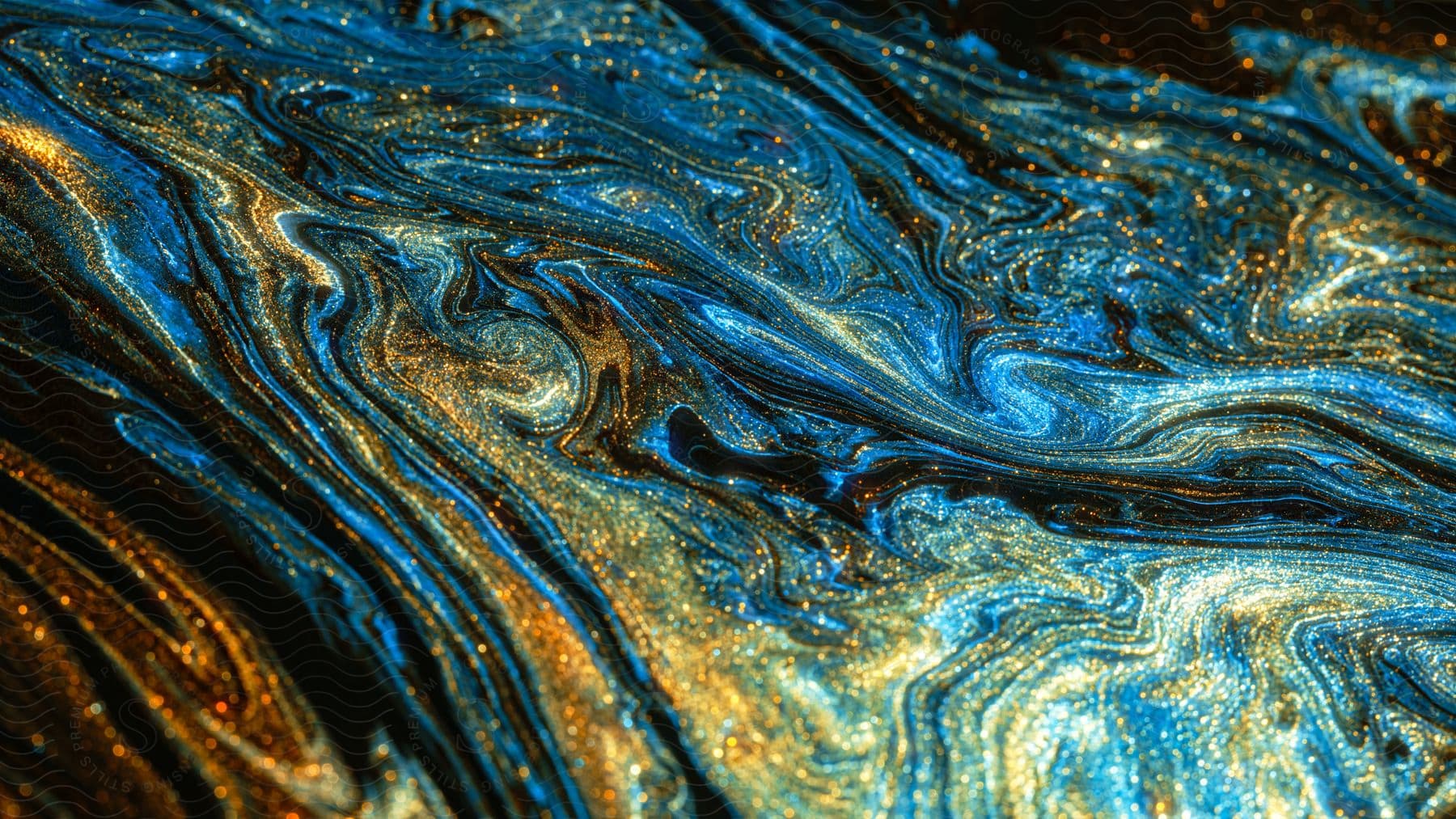 Blue, gold, and orange fluid all swirling together