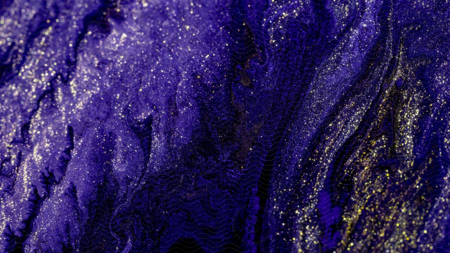 A close-up abstract digital art of a swirling purple and gold liquid with gold glitters.