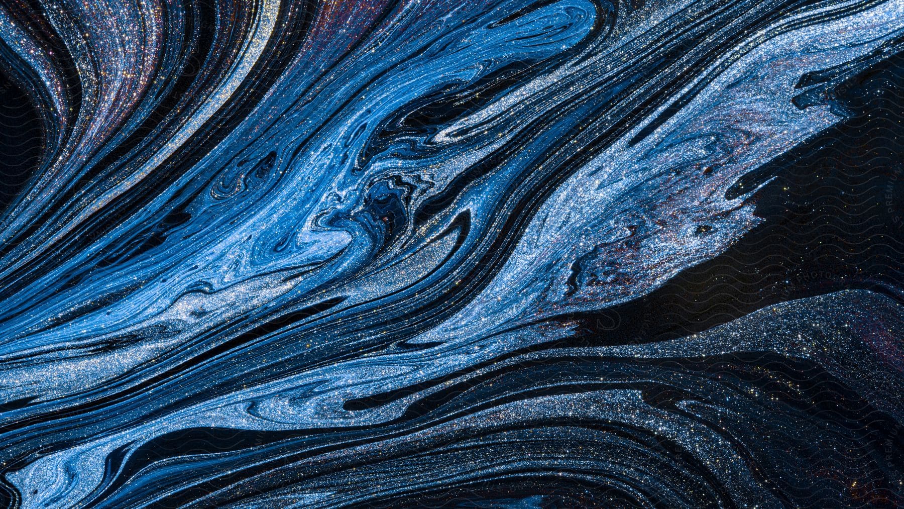 Bands of blue liquid stripes sparkle as they stretch across a dark environment