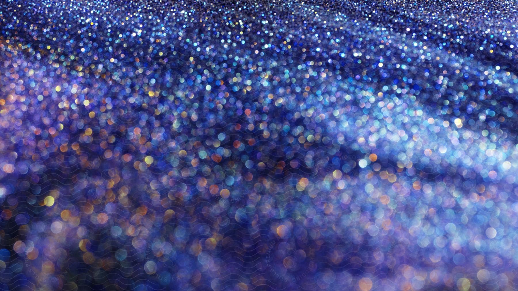 Colorful glitter sparkles and shines in a purple environment