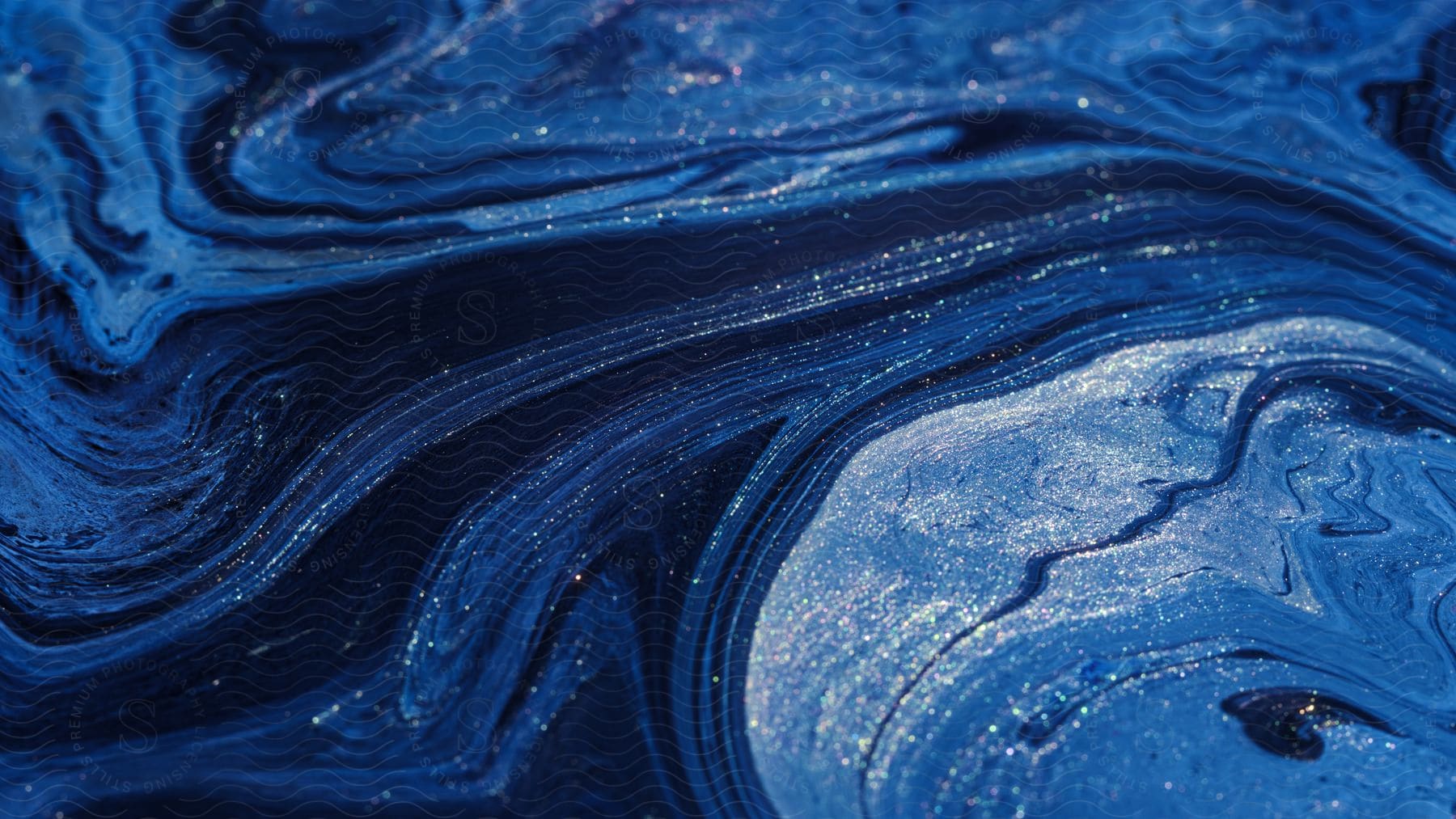 Abstract digital art of blue and white liquid mixing and flowing with glitter and dark liquid,