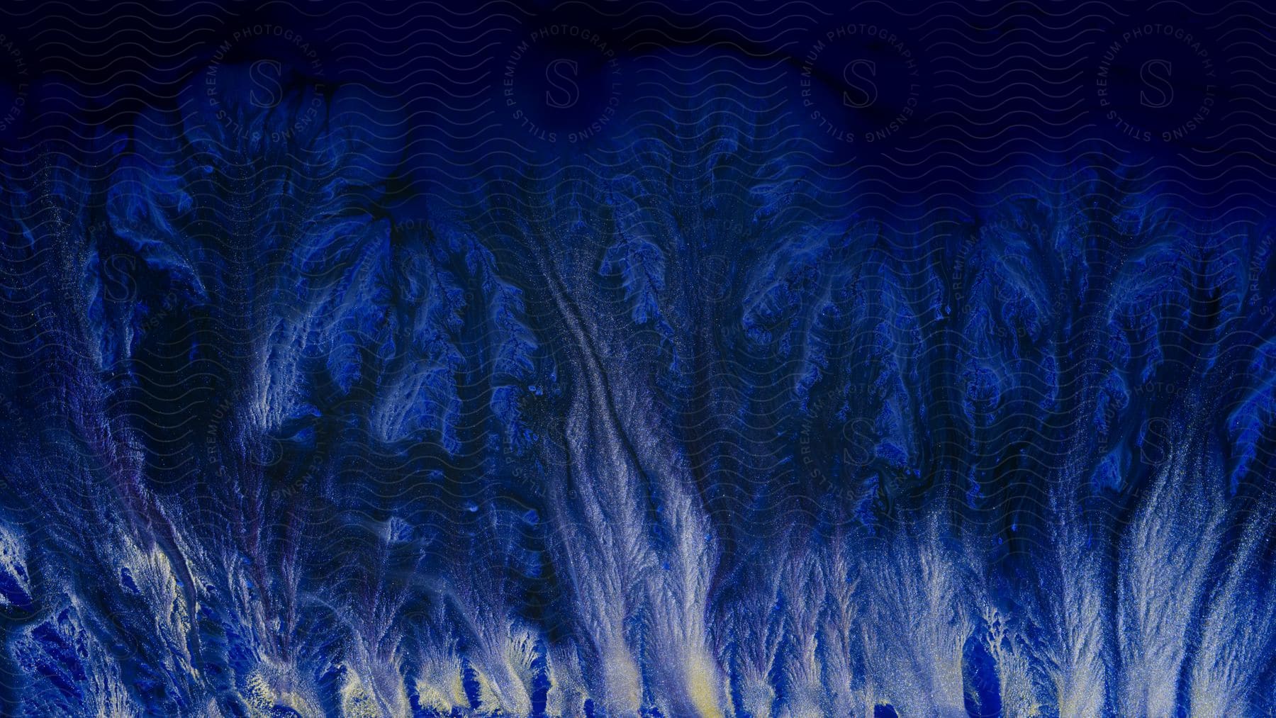 Abstract digital art of blue and white liquid mixing and flowing upwards, creating vein-like patterns.