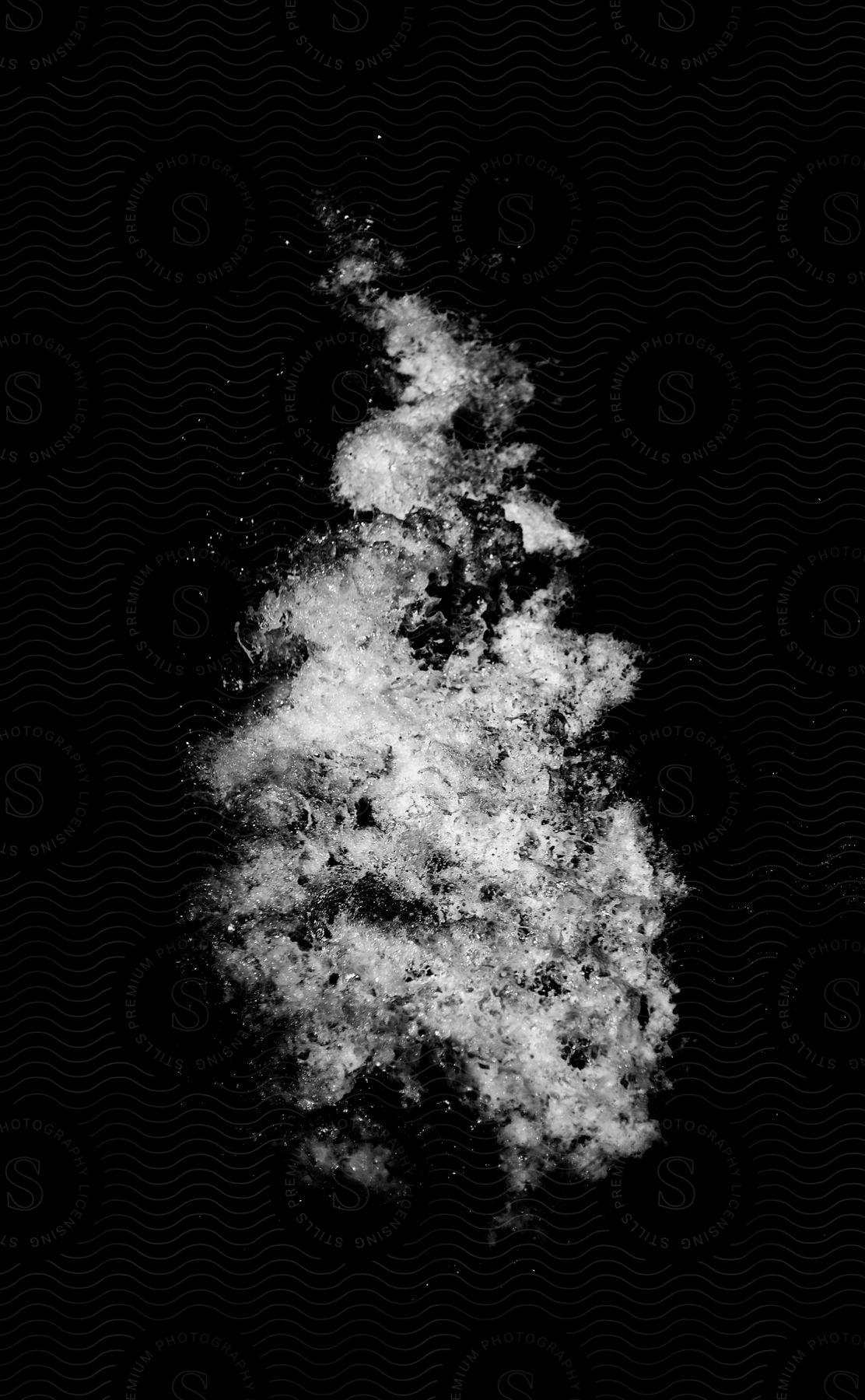 Ice in motion of white color powder on dark background.