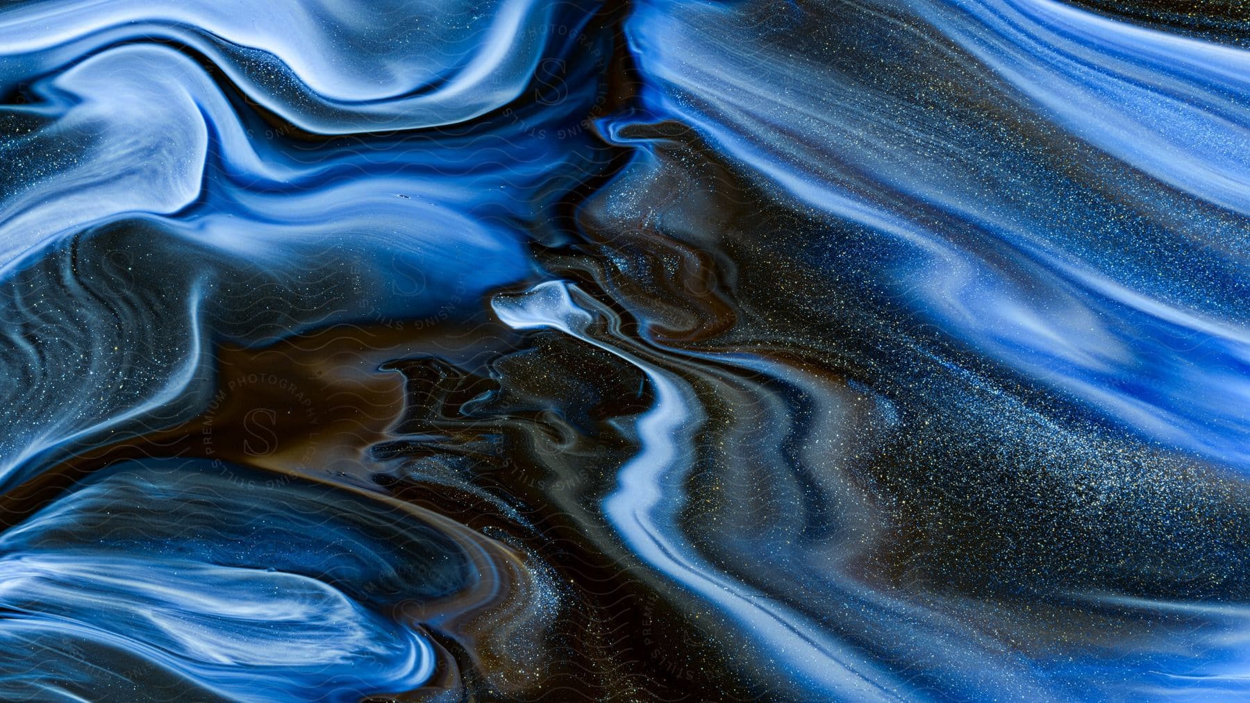 Blue, Black, And Brown Liquid All Mixing Together