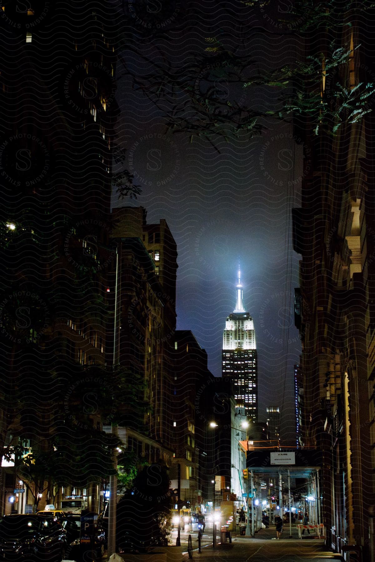 The Empire State building in New York City lit up at night time.