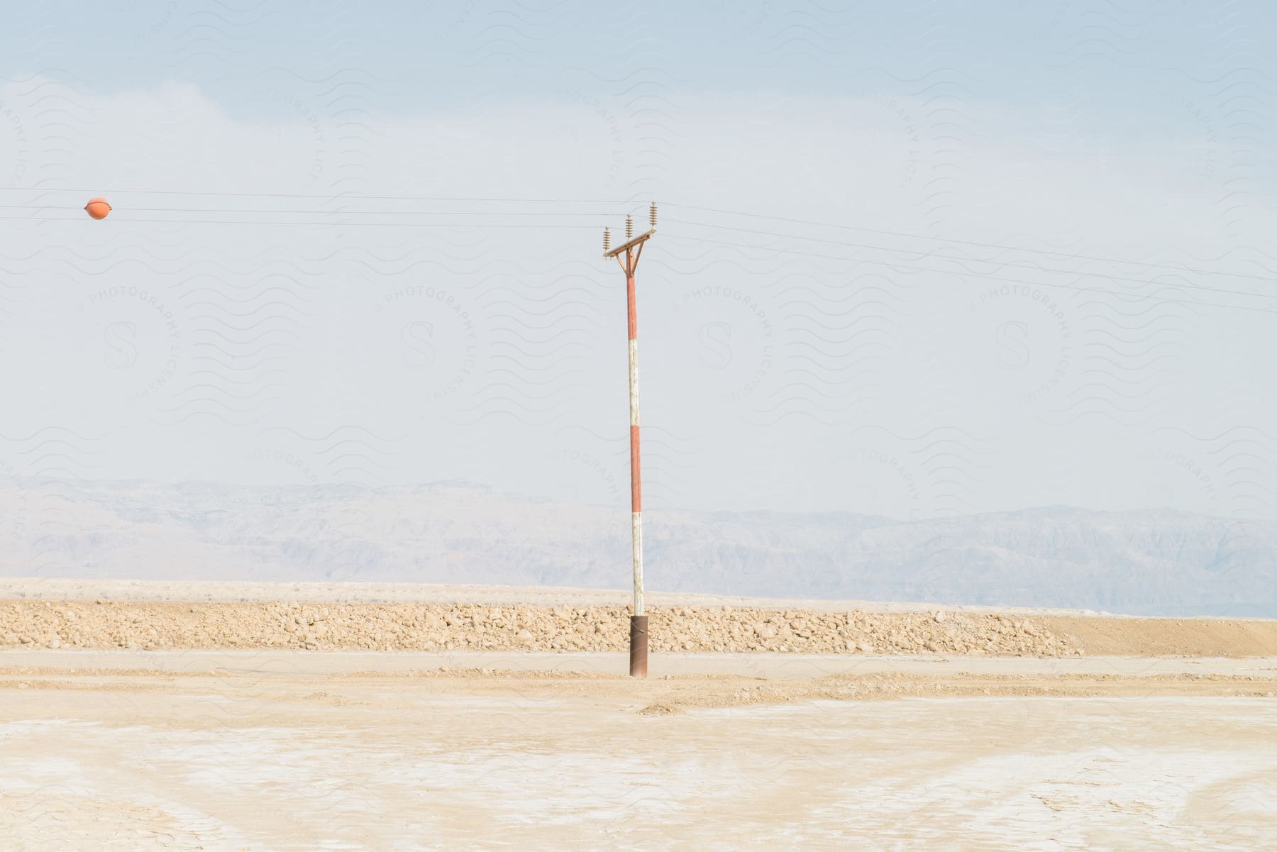 a utility pole sits along a rural highway