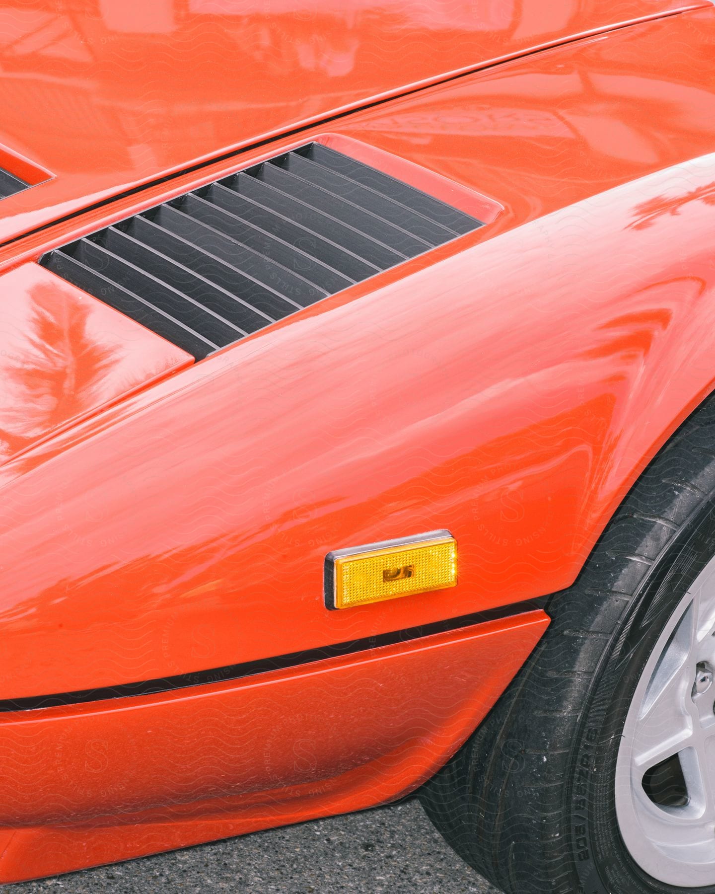 A red sports car shines in the sunlight