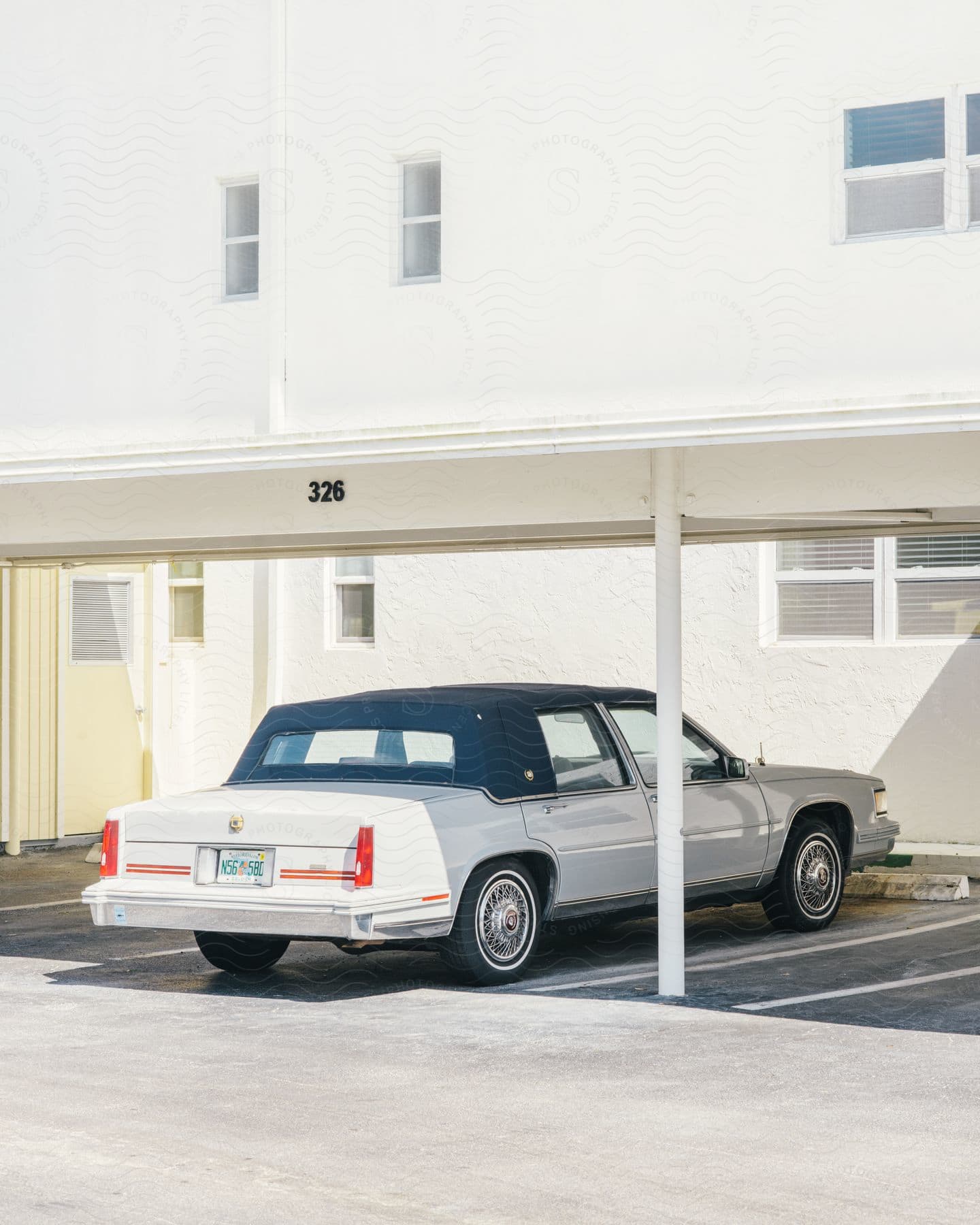 a classic car is parked outside an apartment building