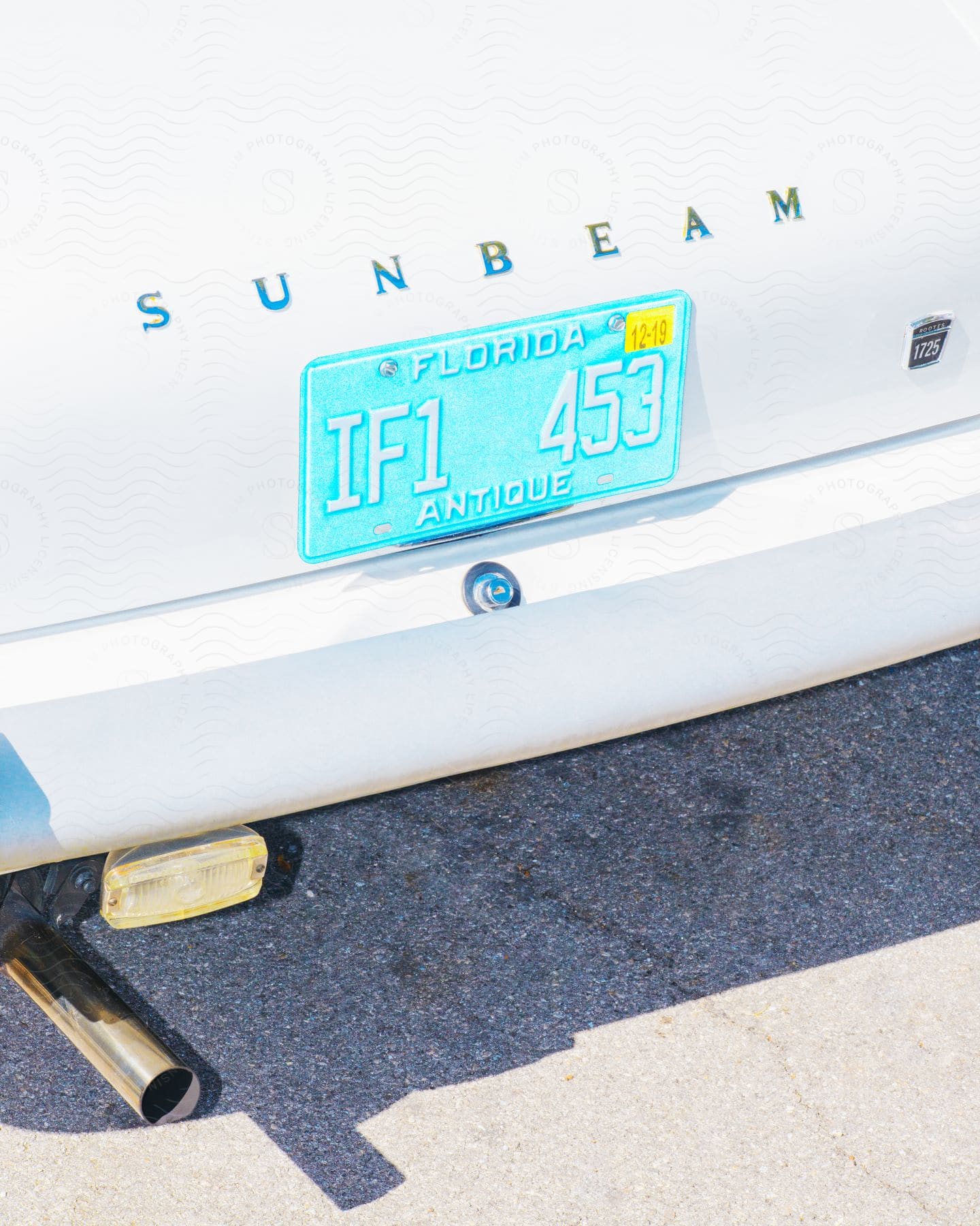 Florida license plate on rear of white sunbeam vehicle