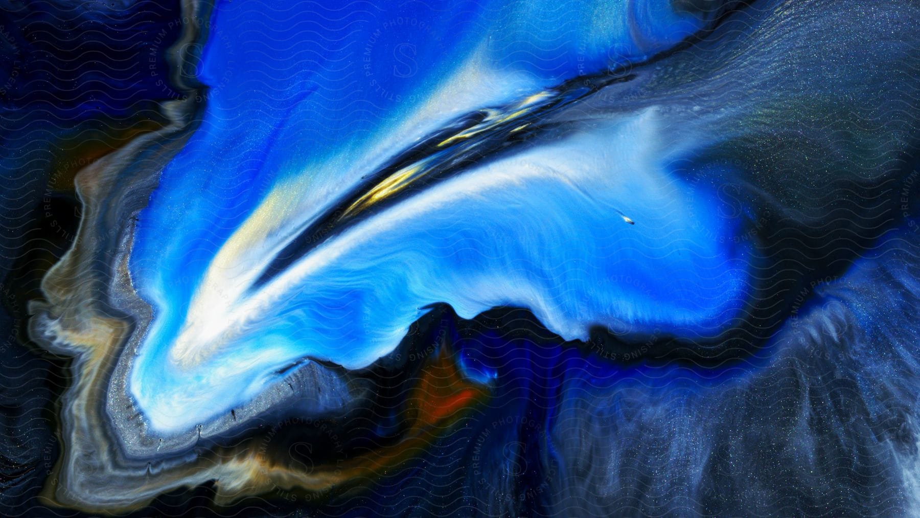 Swirling liquid with various colors in it like gold and blue