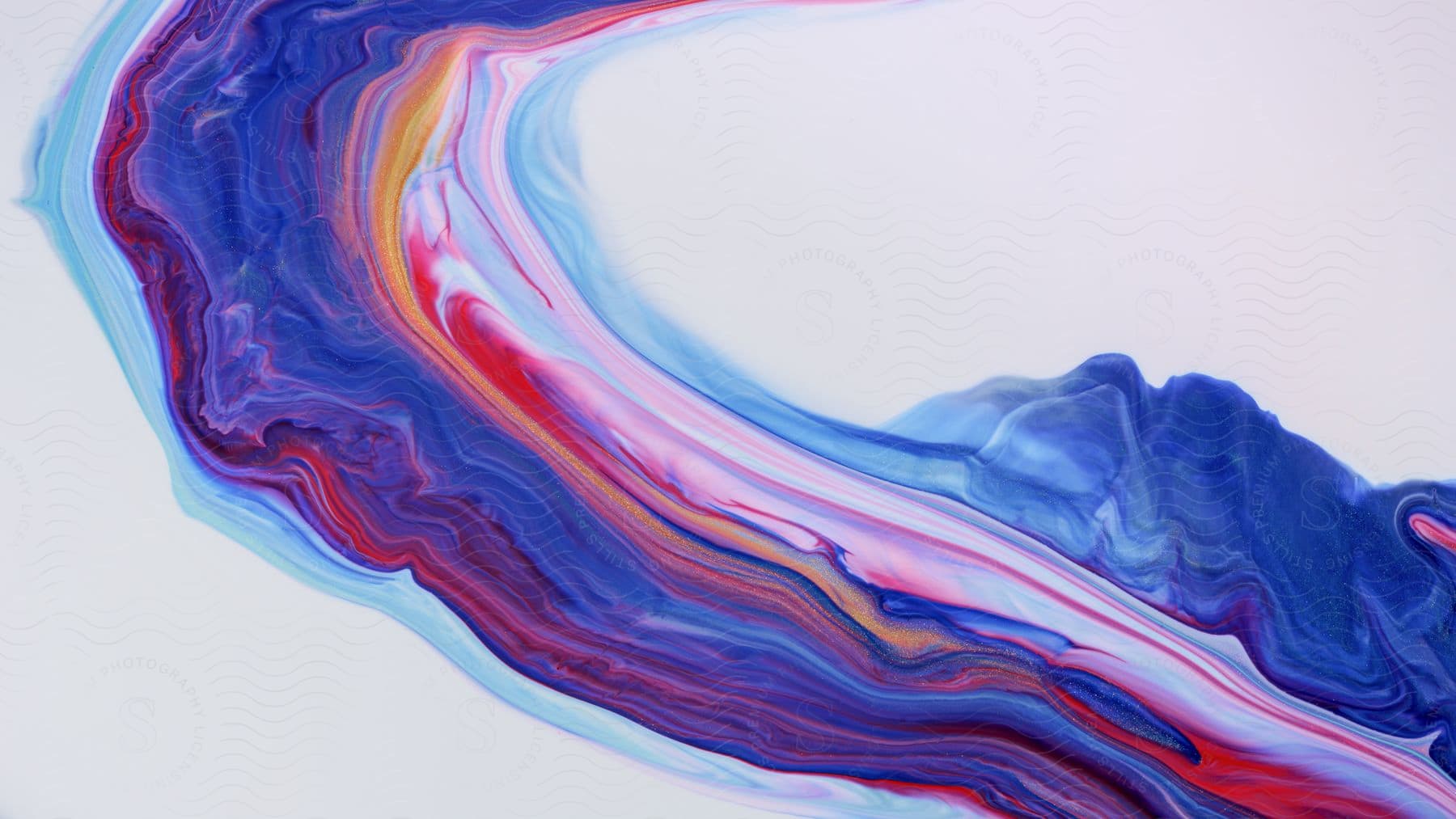 Swirling colored liquid with red, blue, purple and orange