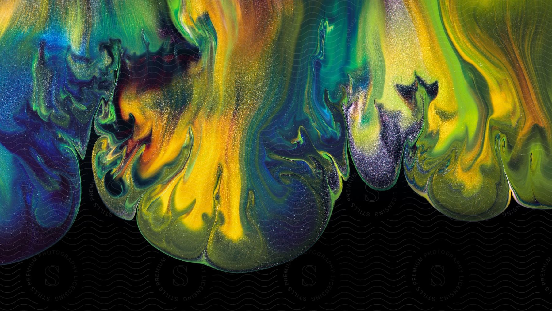 A colorful abstract piece of art with liquid paint running down from the top.