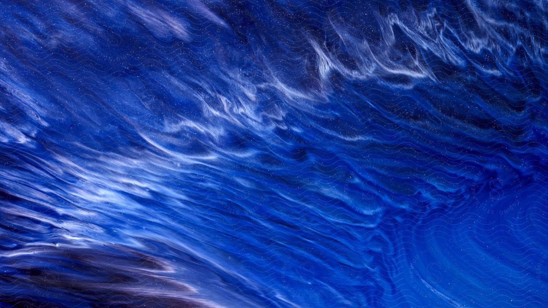 Multiple streaks of a wavy blue fluid appear to radiate from circular portion of this abstract imagery.