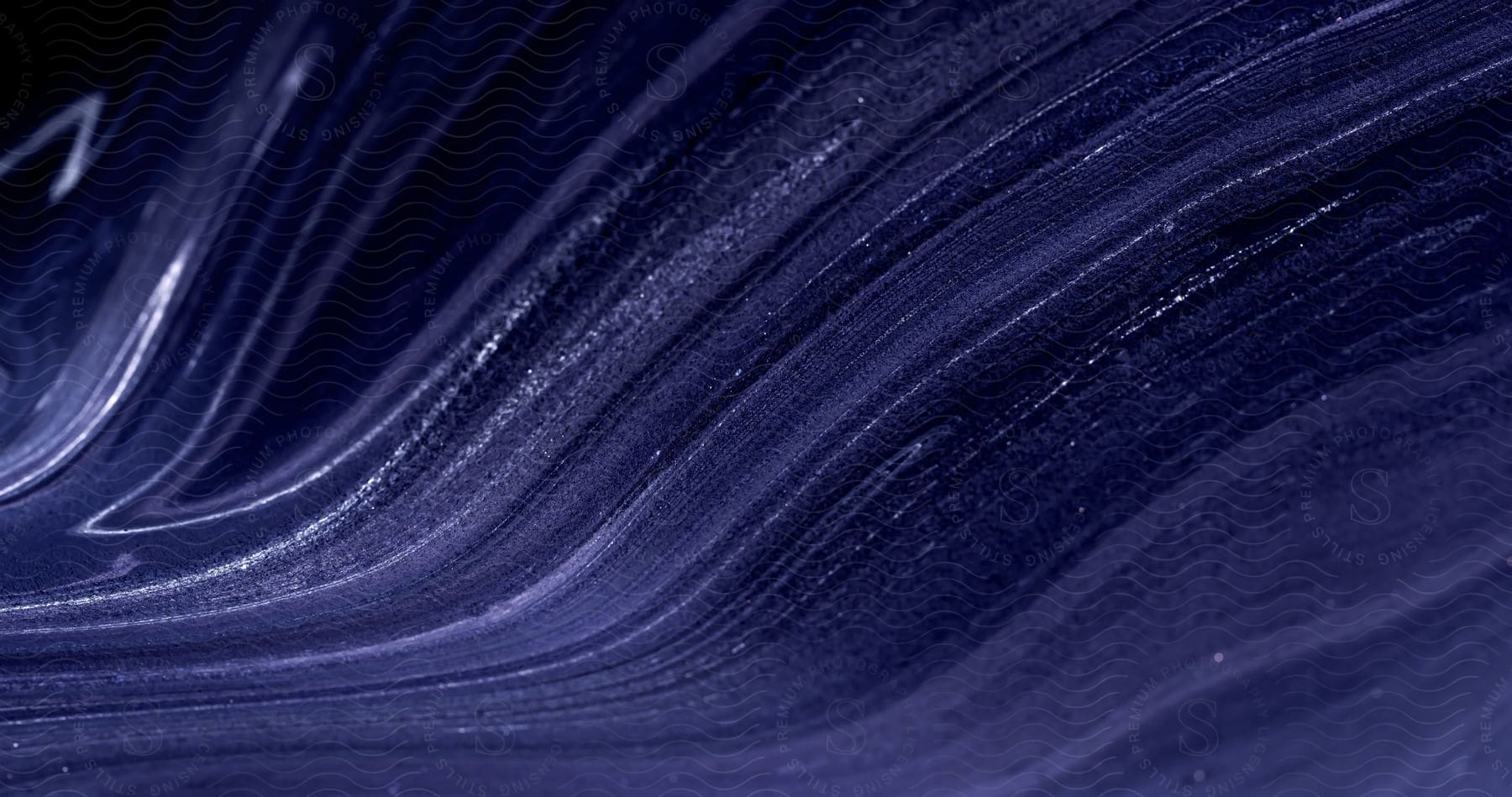 Stock photo of thin streaks of lighter violet color and white dots simulating flow on a darker violet background