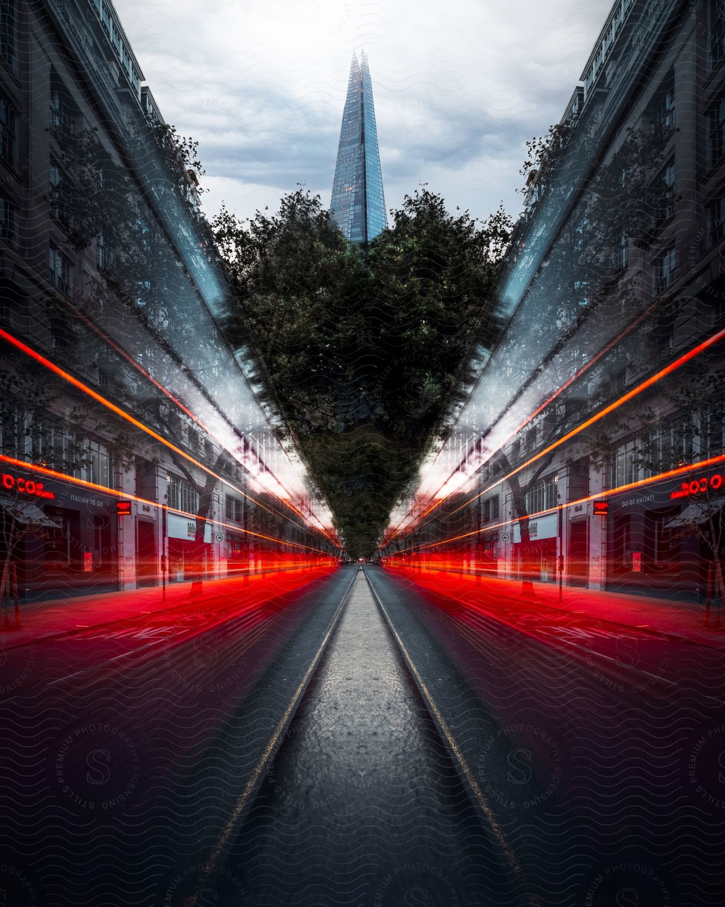 The Shard building in London stands tall above a street lined with commercial buildings.