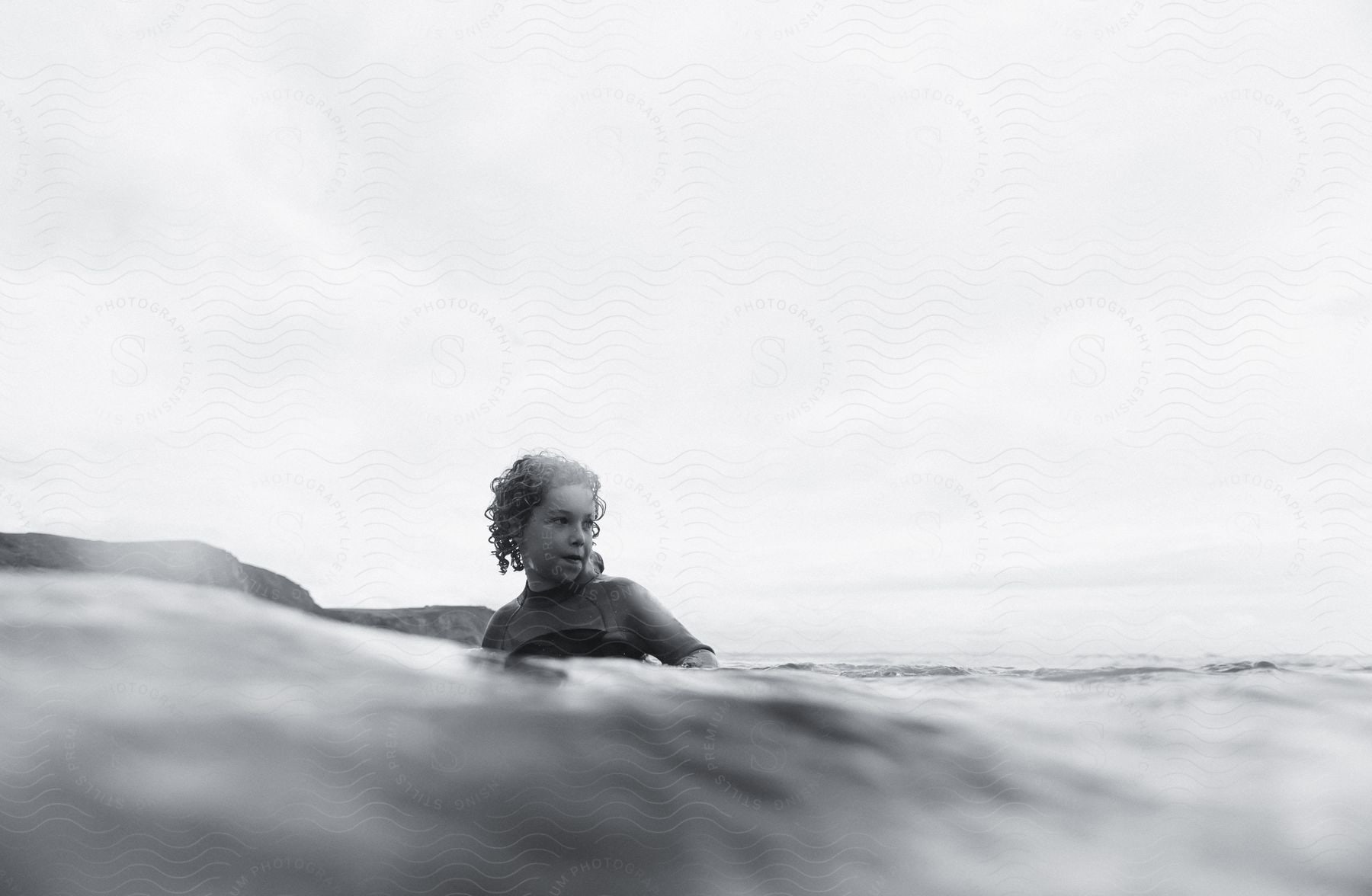 A Boy Wearing A Wetsuit In The Sea