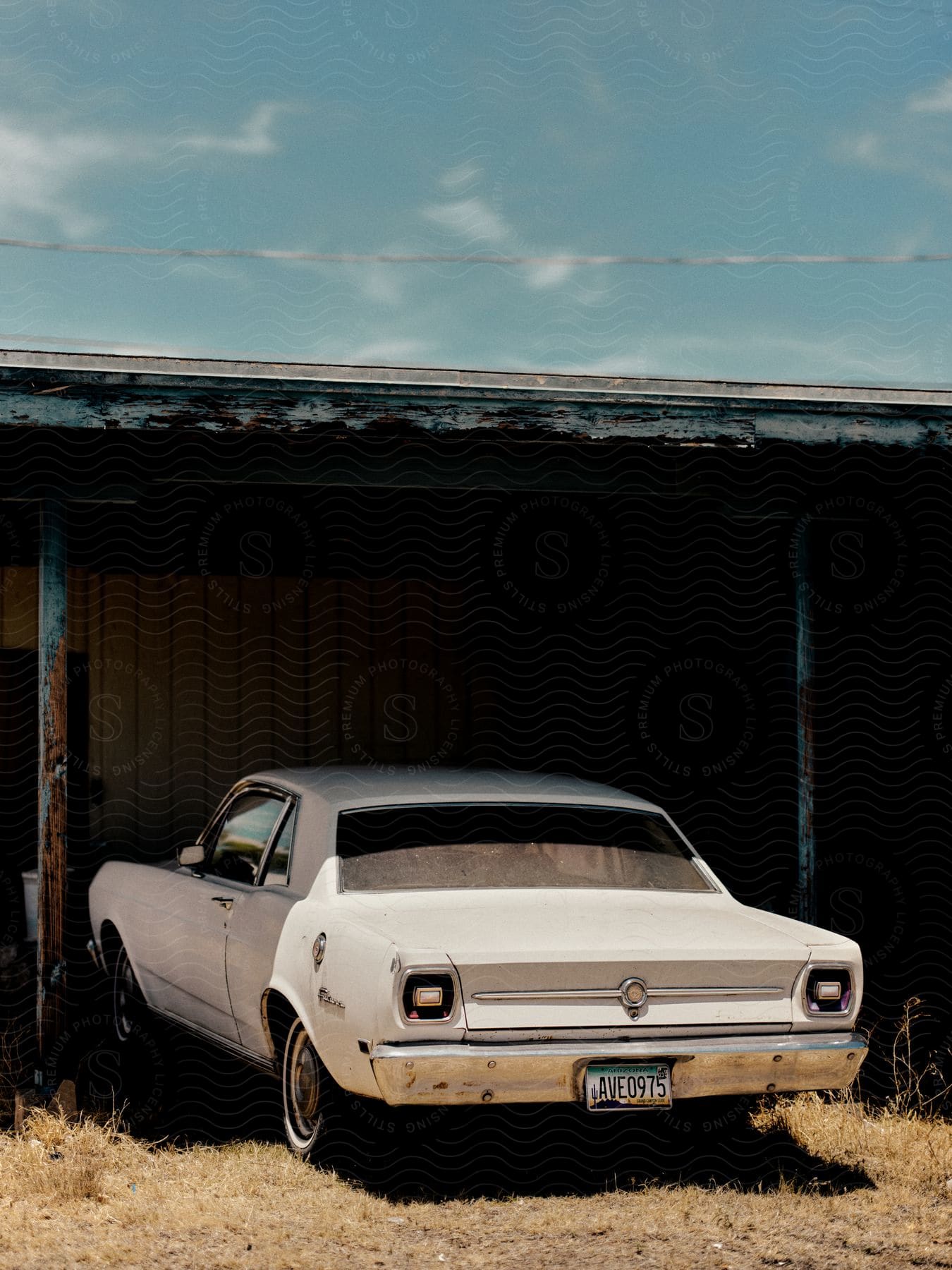 White Ford Falcon parked in a garage.