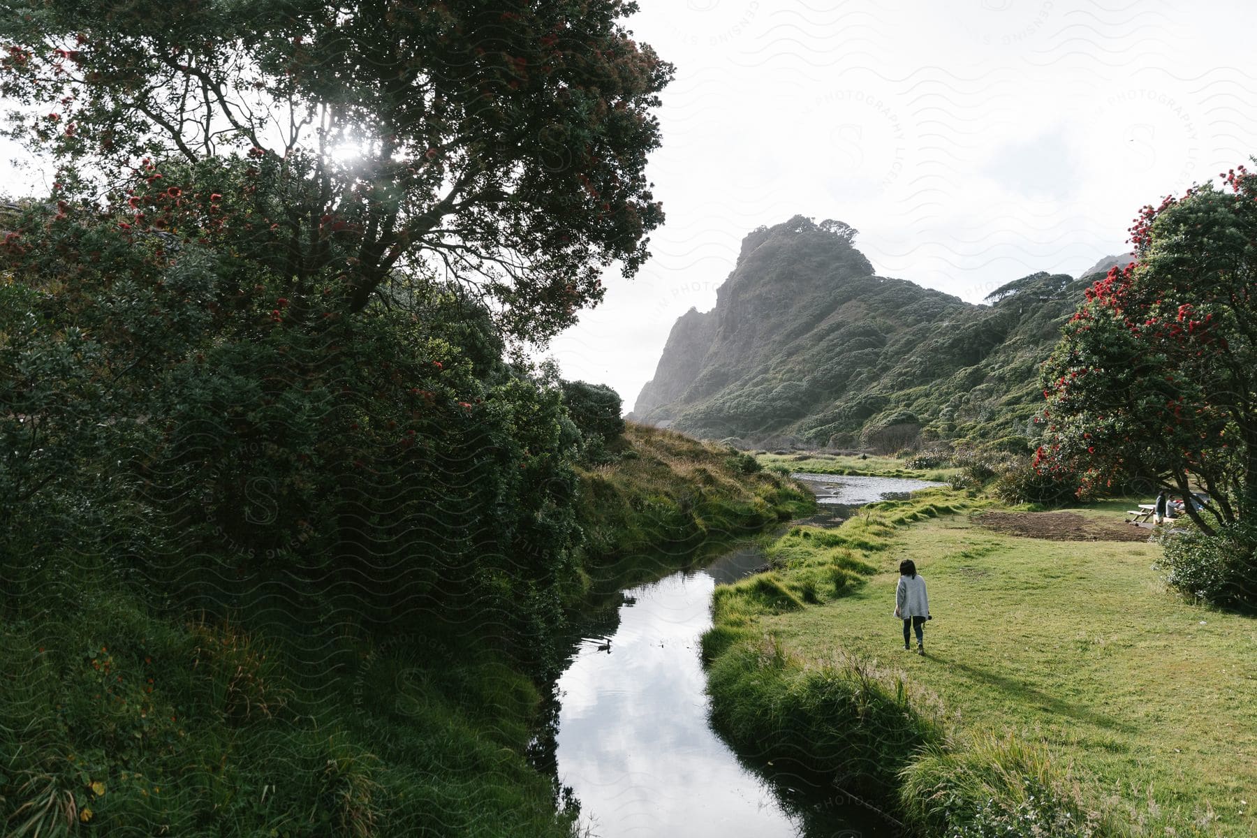 A girl walking along the edge of a river