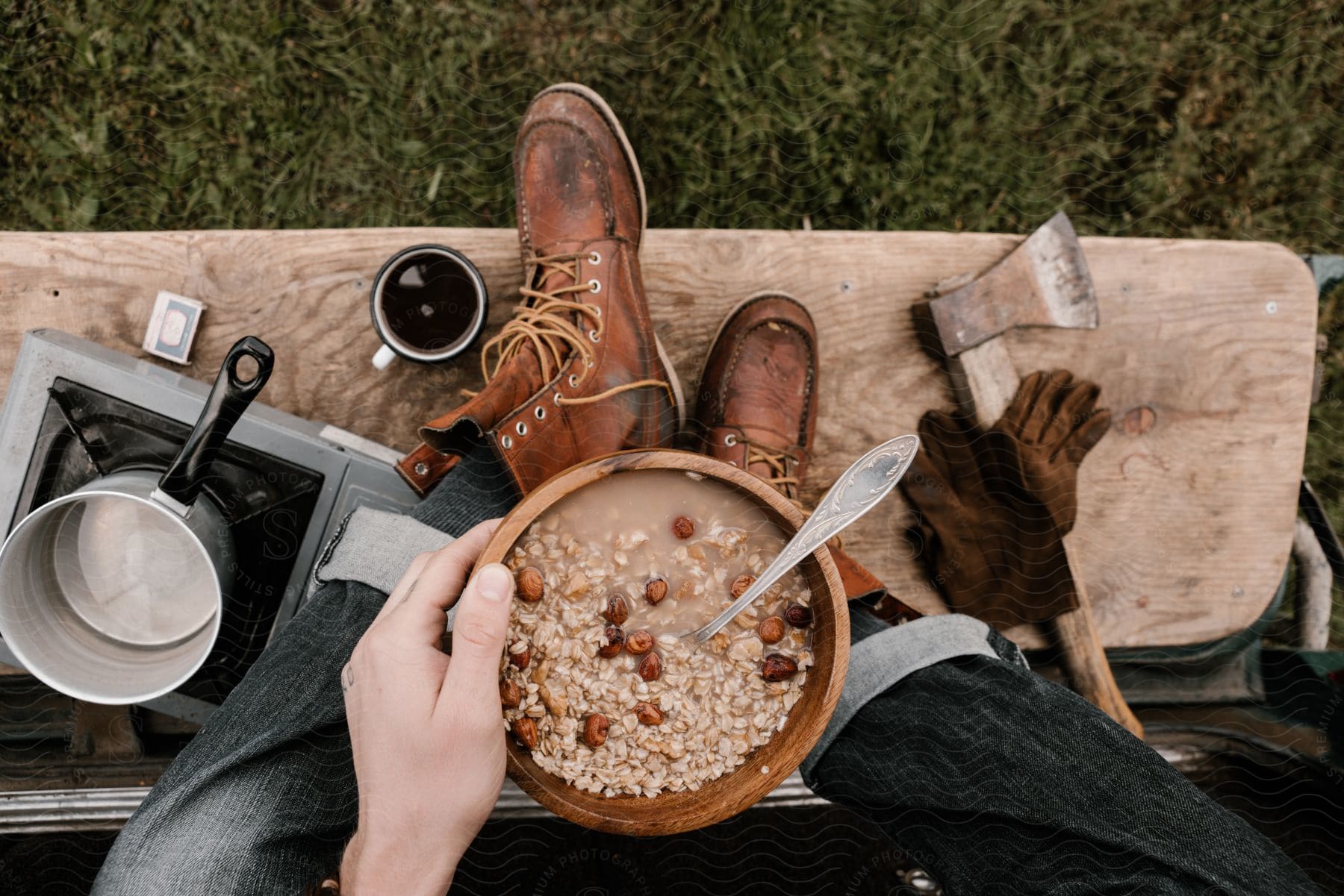 A man is holding a bowl of oatmeal outside.