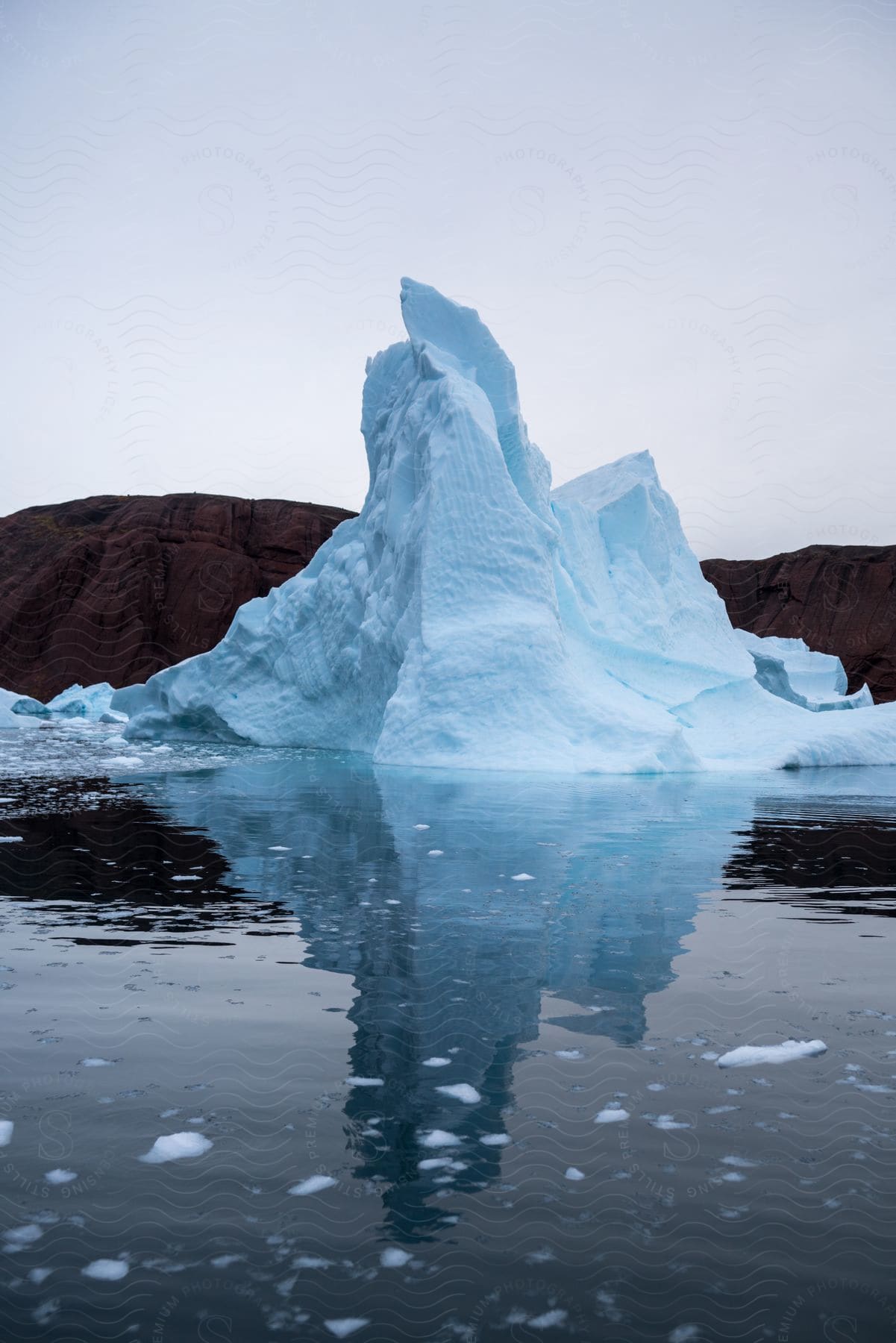 floating ice cap next to the water to the one side and to land at the other